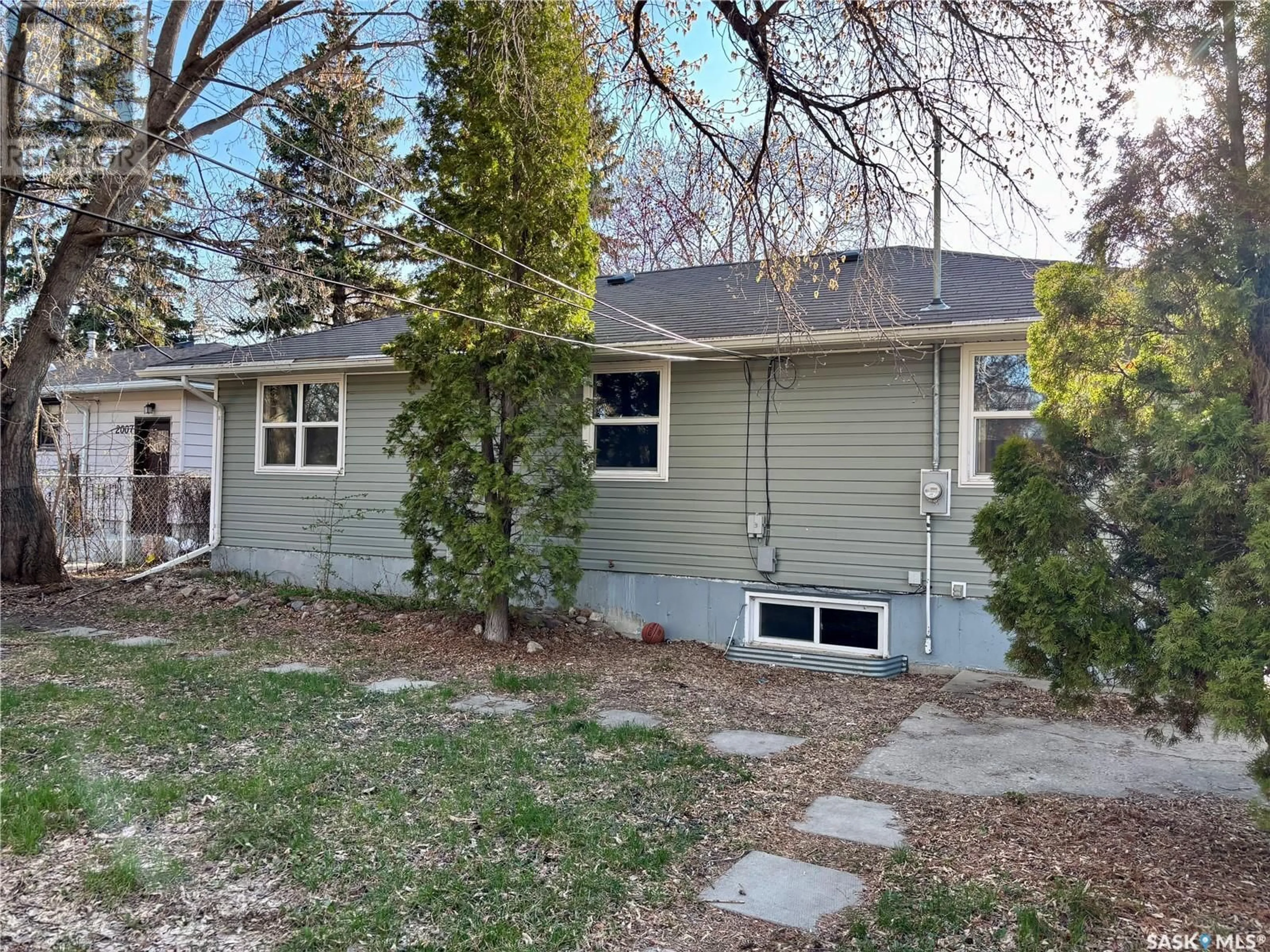 Home with vinyl exterior material, street for 2005 CLARENCE AVENUE, Saskatoon Saskatchewan S7J1L2