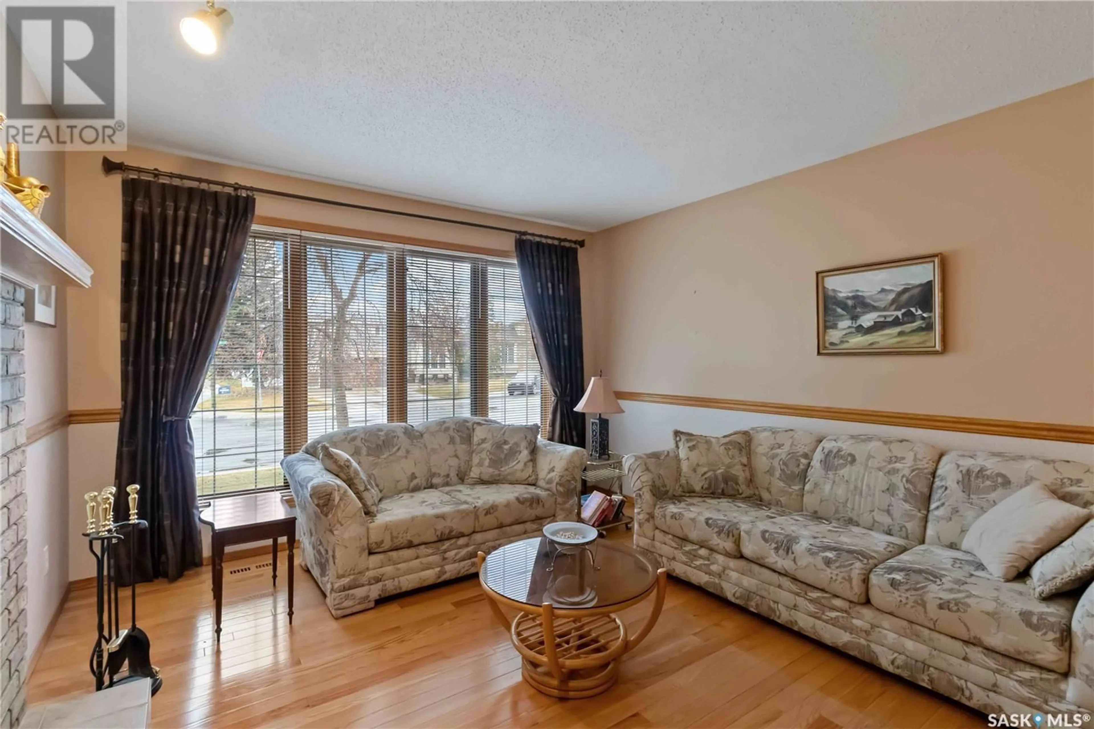 Living room with furniture, wood/laminate floor for 702 STEIGER PLACE, Saskatoon Saskatchewan S7N4K3