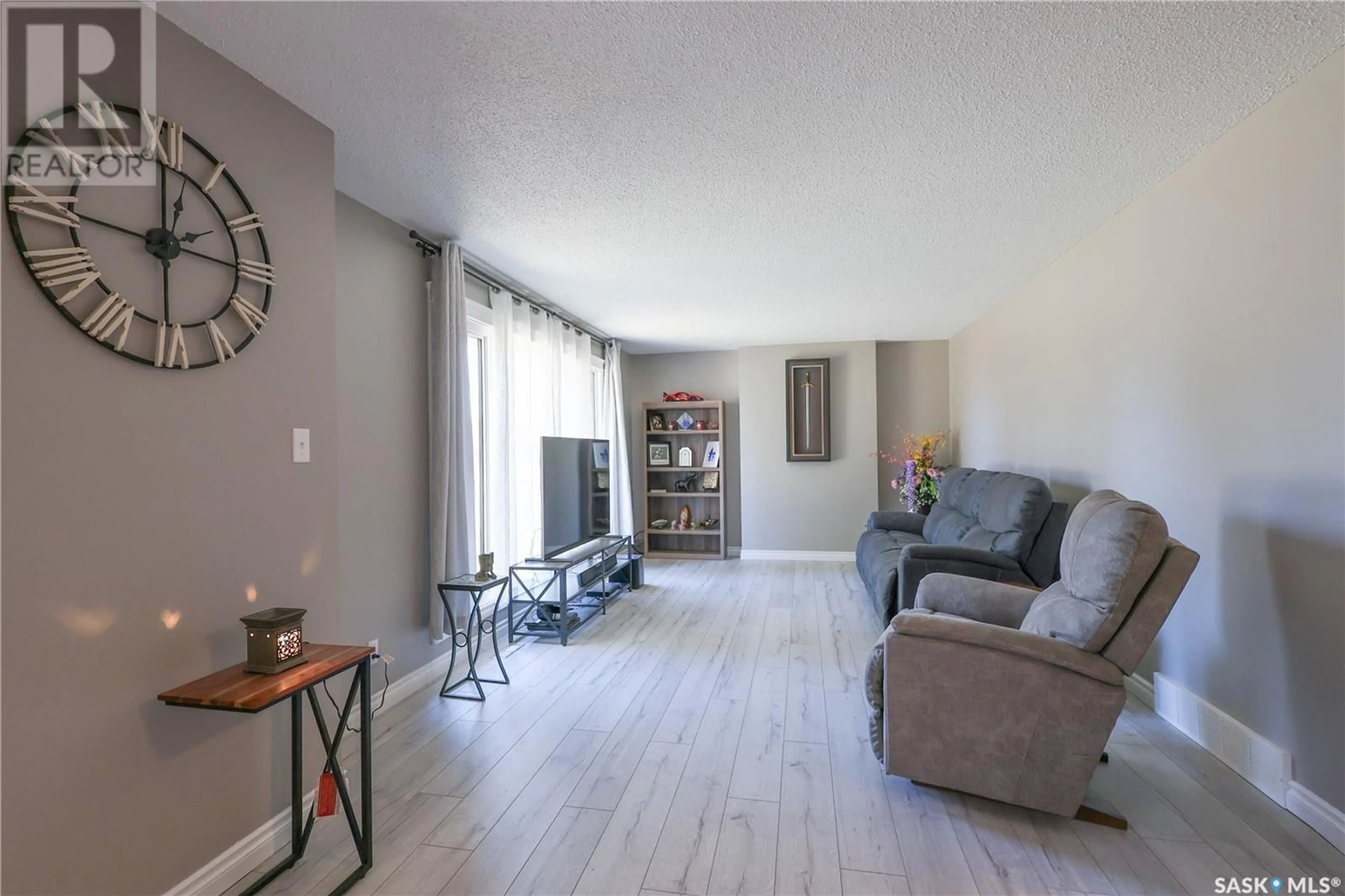 Living room with furniture, wood/laminate floor for 401 CEDAR AVENUE, Buckland Rm No. 491 Saskatchewan S6V5R3