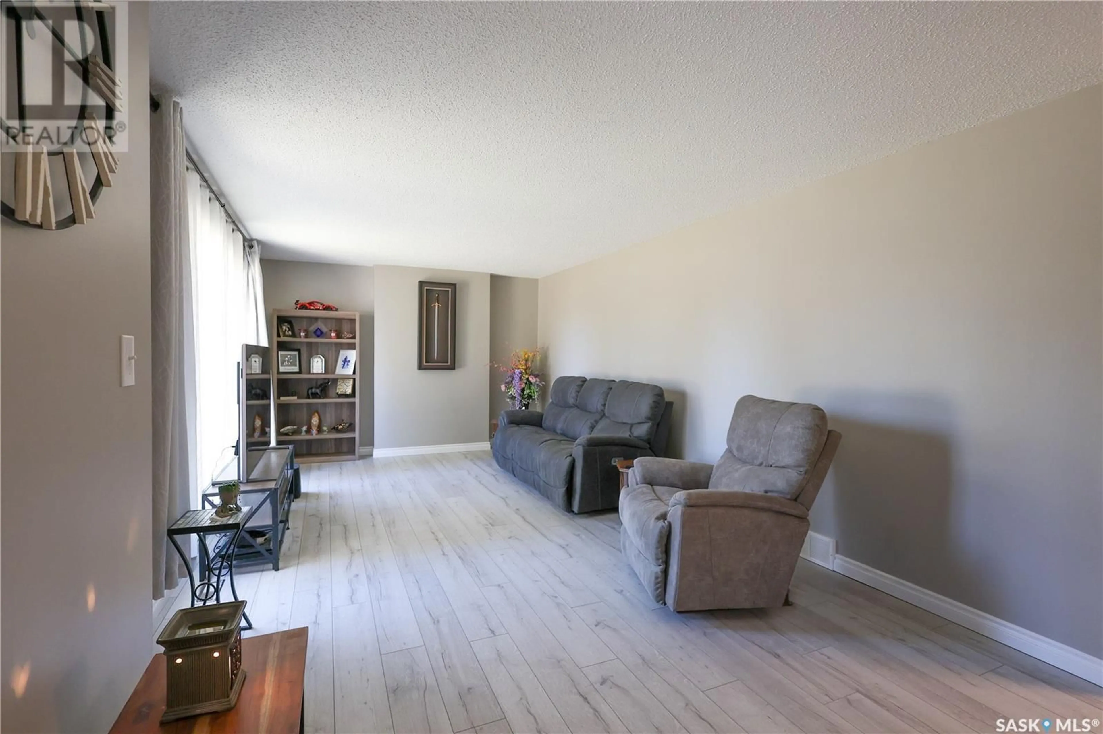Living room with furniture, wood/laminate floor for 401 CEDAR AVENUE, Buckland Rm No. 491 Saskatchewan S6V5R3
