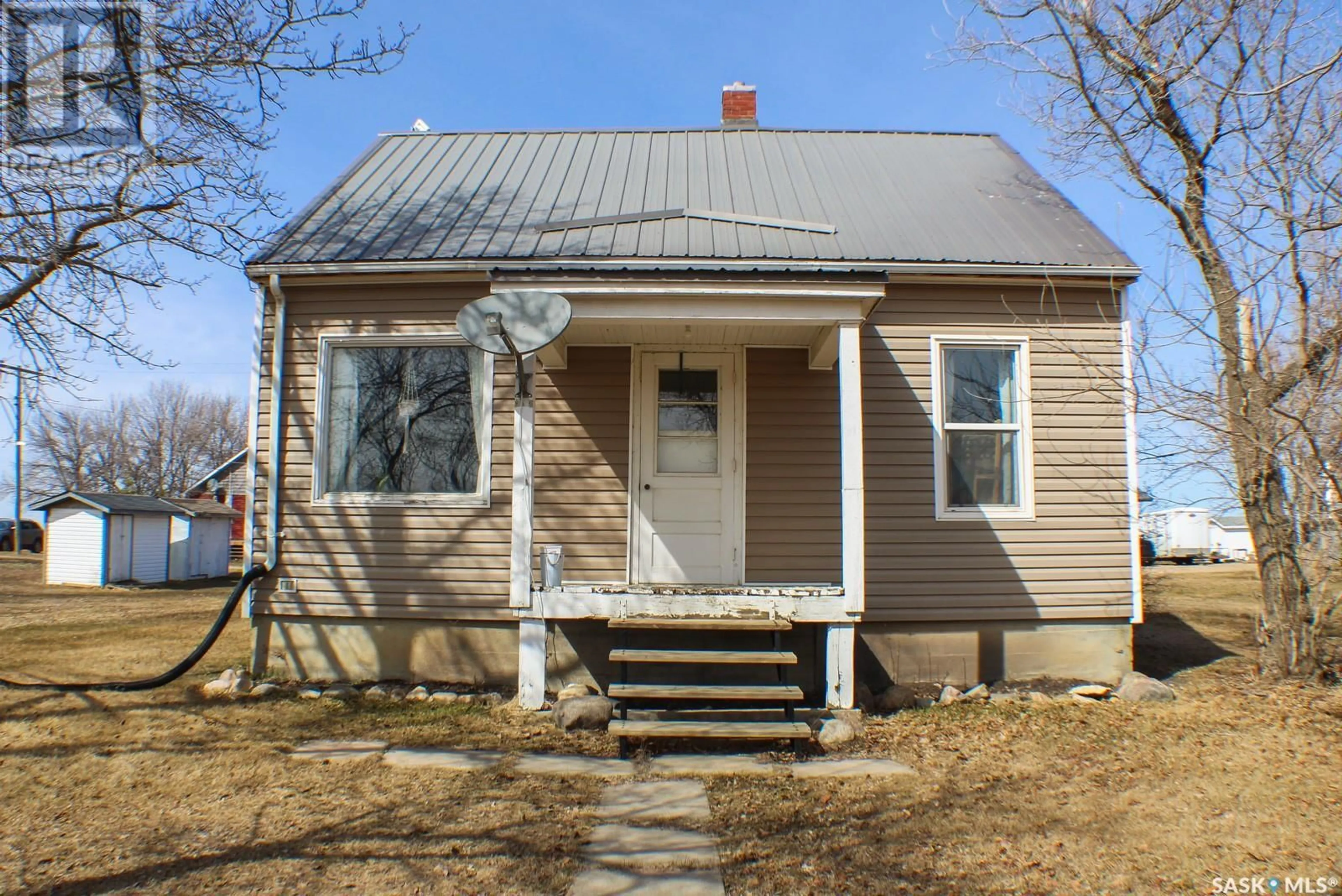 Home with vinyl exterior material, street for 235 1ST STREET, Beatty Saskatchewan S0J0C0