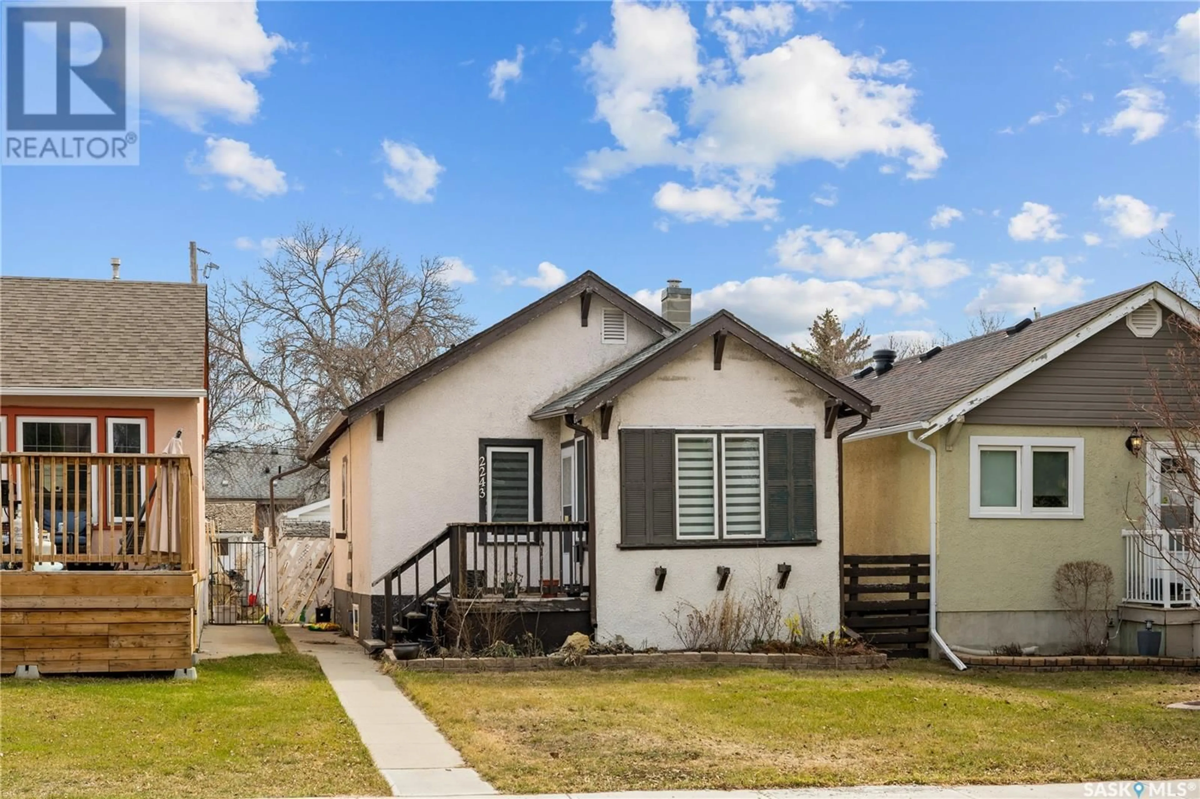 Home with vinyl exterior material, street for 2243 QUEEN STREET, Regina Saskatchewan S4T4C6
