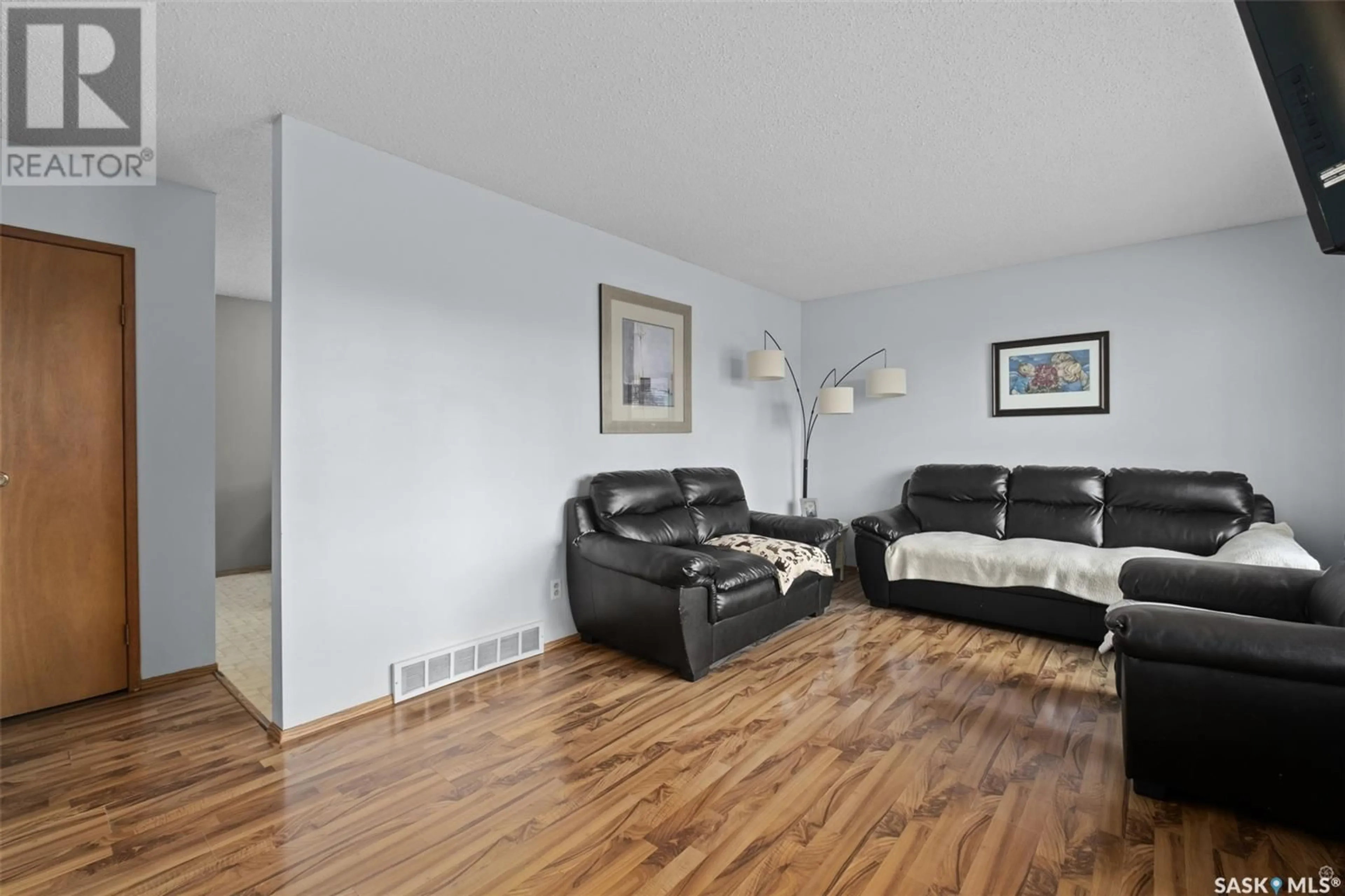 Living room with furniture, wood/laminate floor for 1574 SIBBALD CRESCENT, Prince Albert Saskatchewan S6V6E7
