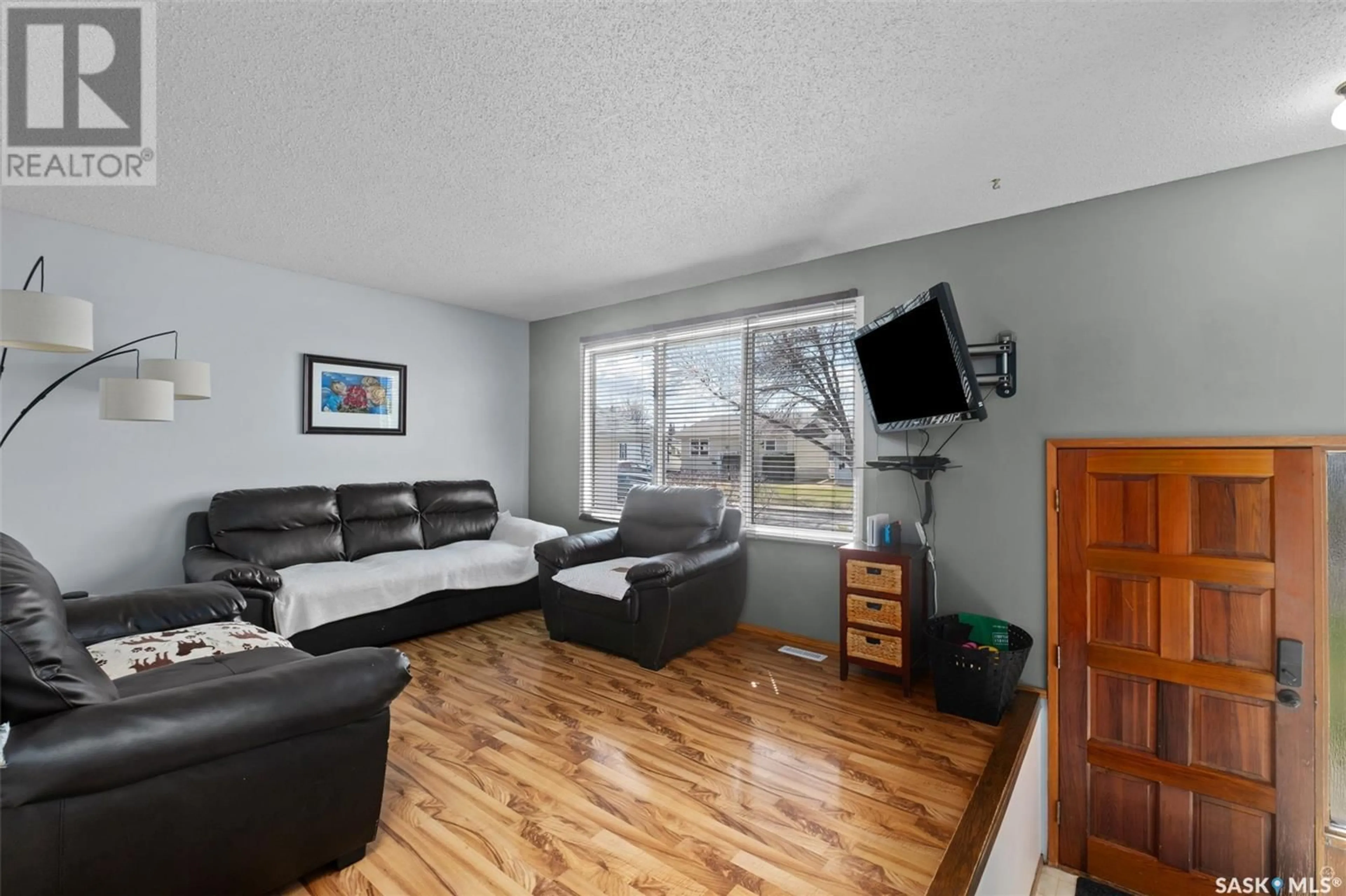 Living room with furniture, wood/laminate floor for 1574 SIBBALD CRESCENT, Prince Albert Saskatchewan S6V6E7