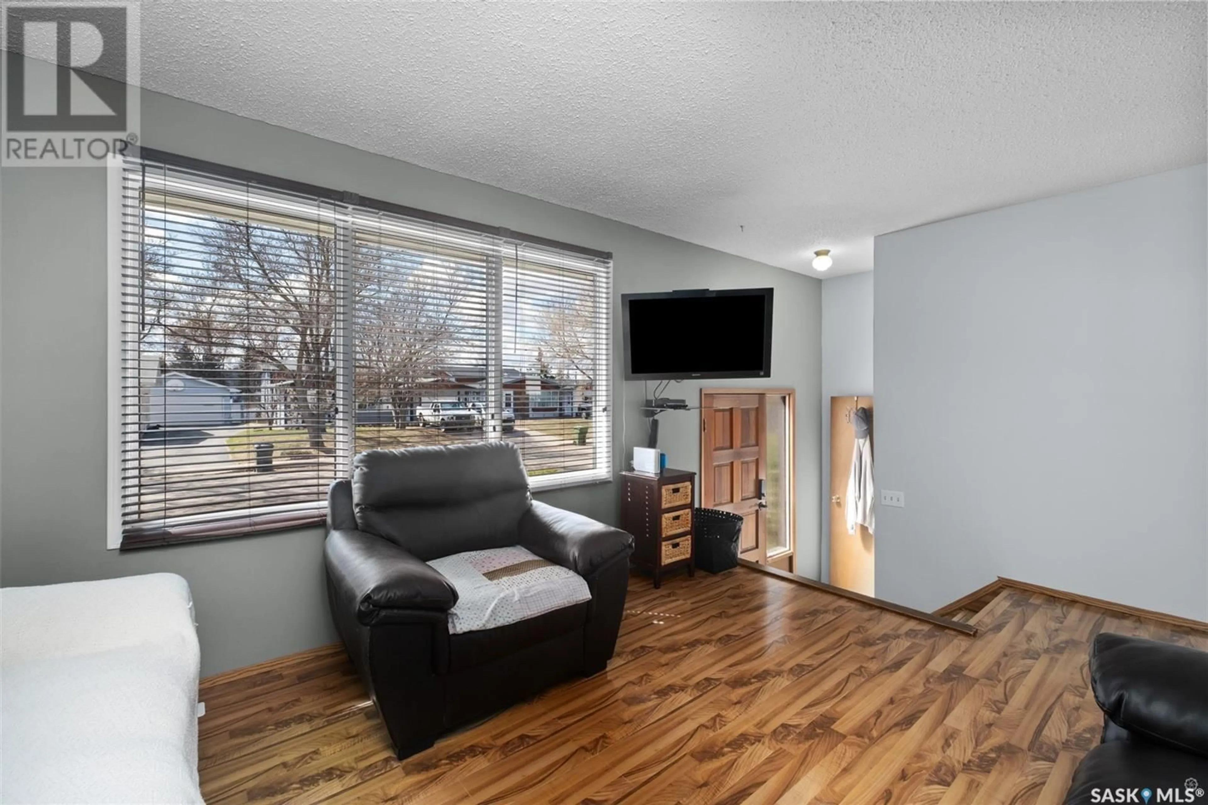 Living room with furniture, wood/laminate floor for 1574 SIBBALD CRESCENT, Prince Albert Saskatchewan S6V6E7