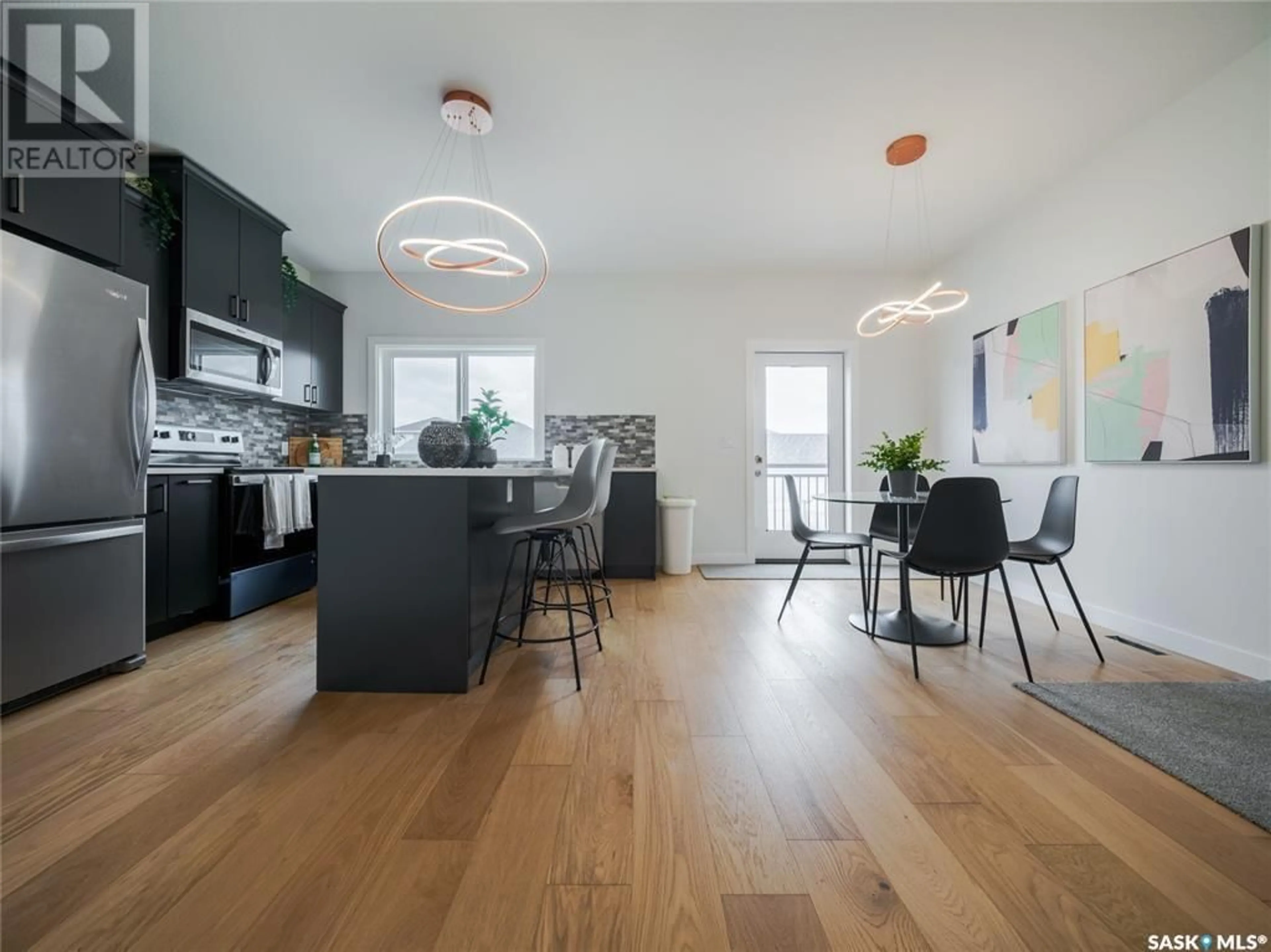 Open concept kitchen, wood/laminate floor for 235 - 205 FEHEREGYHAZI BOULEVARD, Saskatoon Saskatchewan S7W0C2