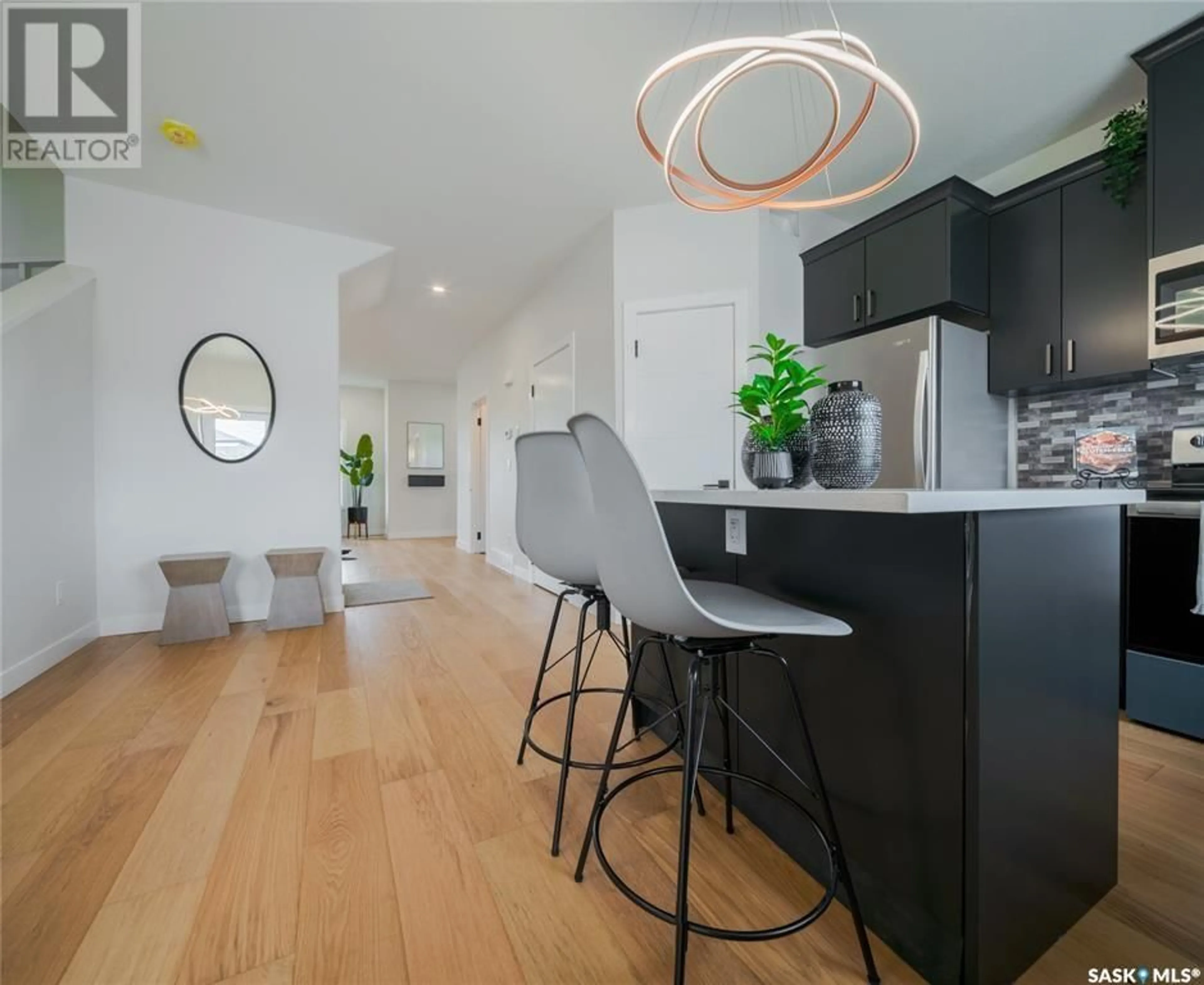 Open concept kitchen, wood/laminate floor for 235 - 205 FEHEREGYHAZI BOULEVARD, Saskatoon Saskatchewan S7W0C2