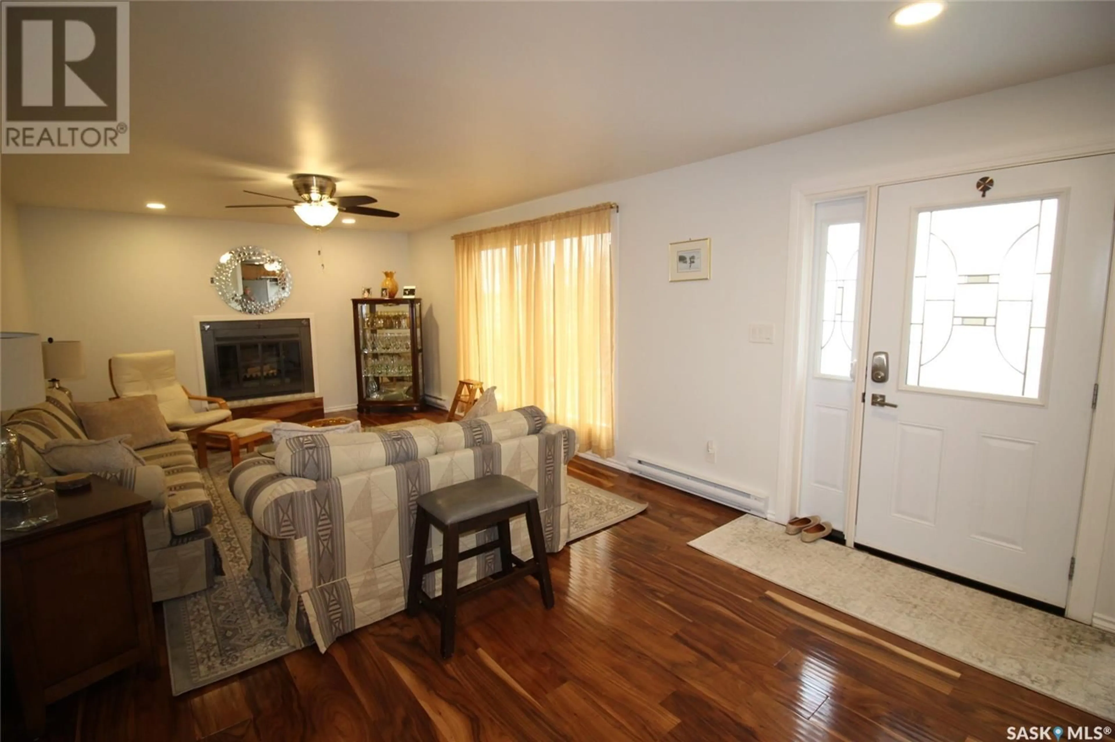 Living room with furniture, wood/laminate floor for HERSCHMILLER ACRES, Bone Creek Rm No. 108 Saskatchewan S0N2M0