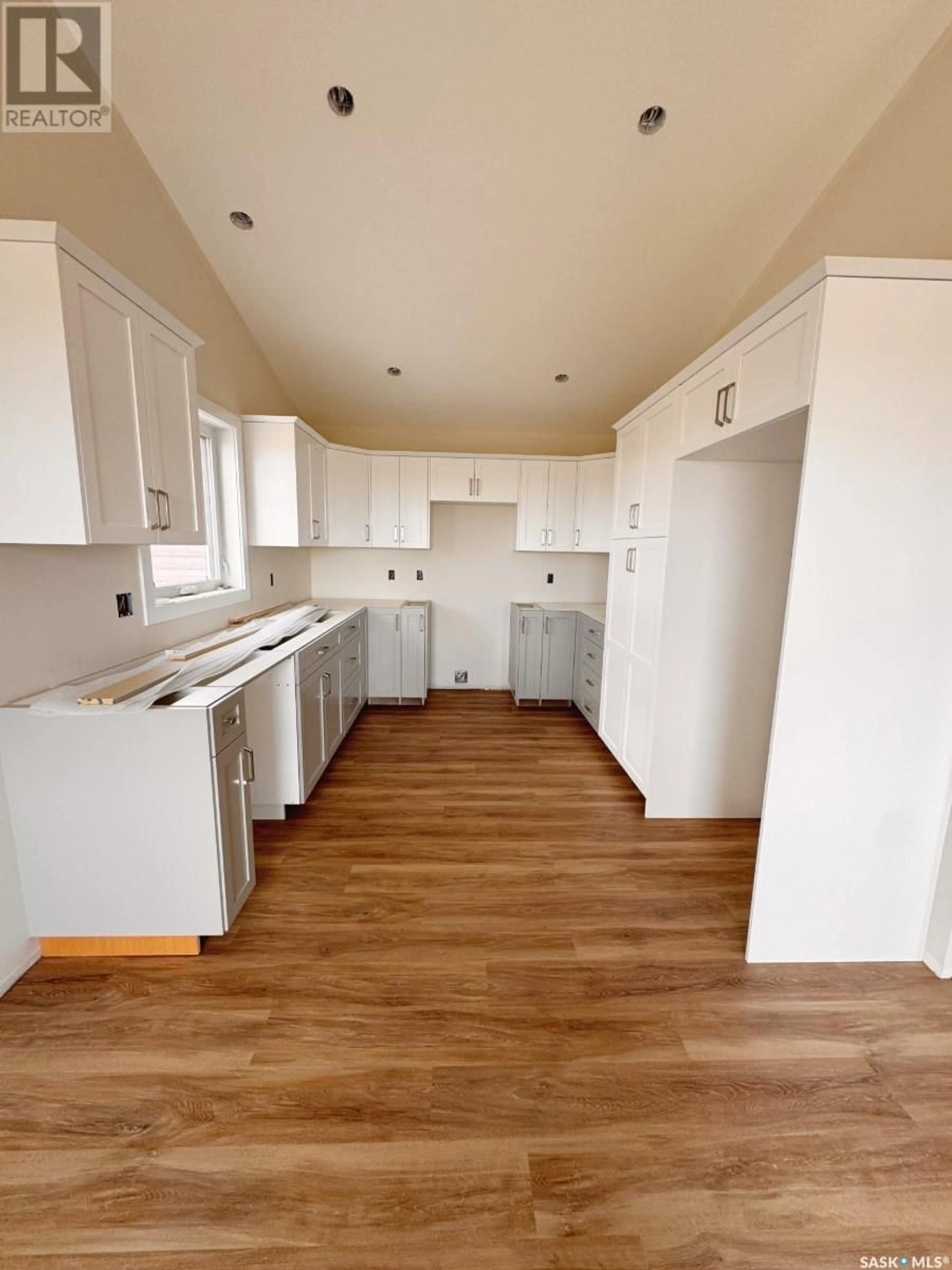 Open concept kitchen, wood/laminate floor for 90 DIEFENBAKER AVENUE, Hague Saskatchewan S0K1X0