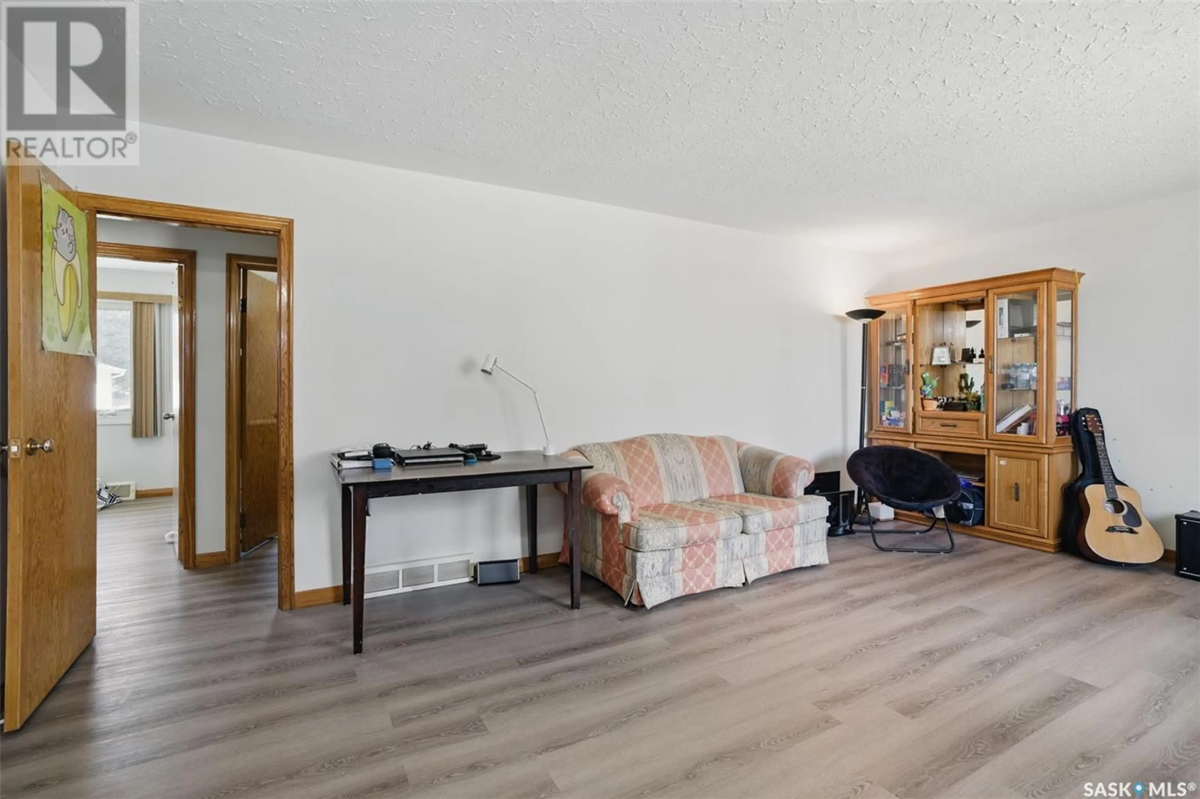 Living room with furniture, wood/laminate floor for 2311 LANSDOWNE AVENUE, Saskatoon Saskatchewan S7J1G8