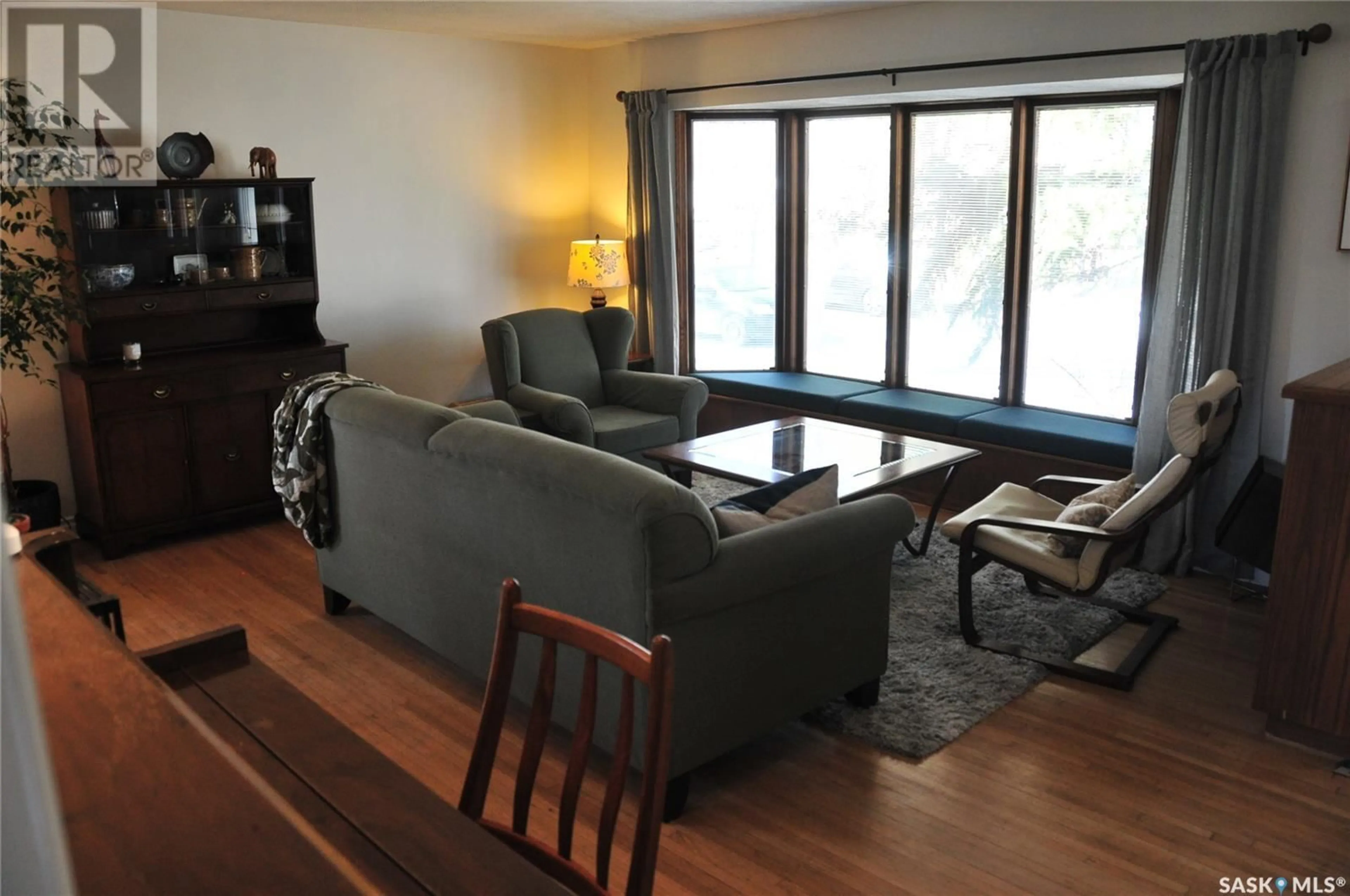 Living room with furniture, wood/laminate floor for 62 HAULTAIN CRESCENT, Regina Saskatchewan S4S4B5