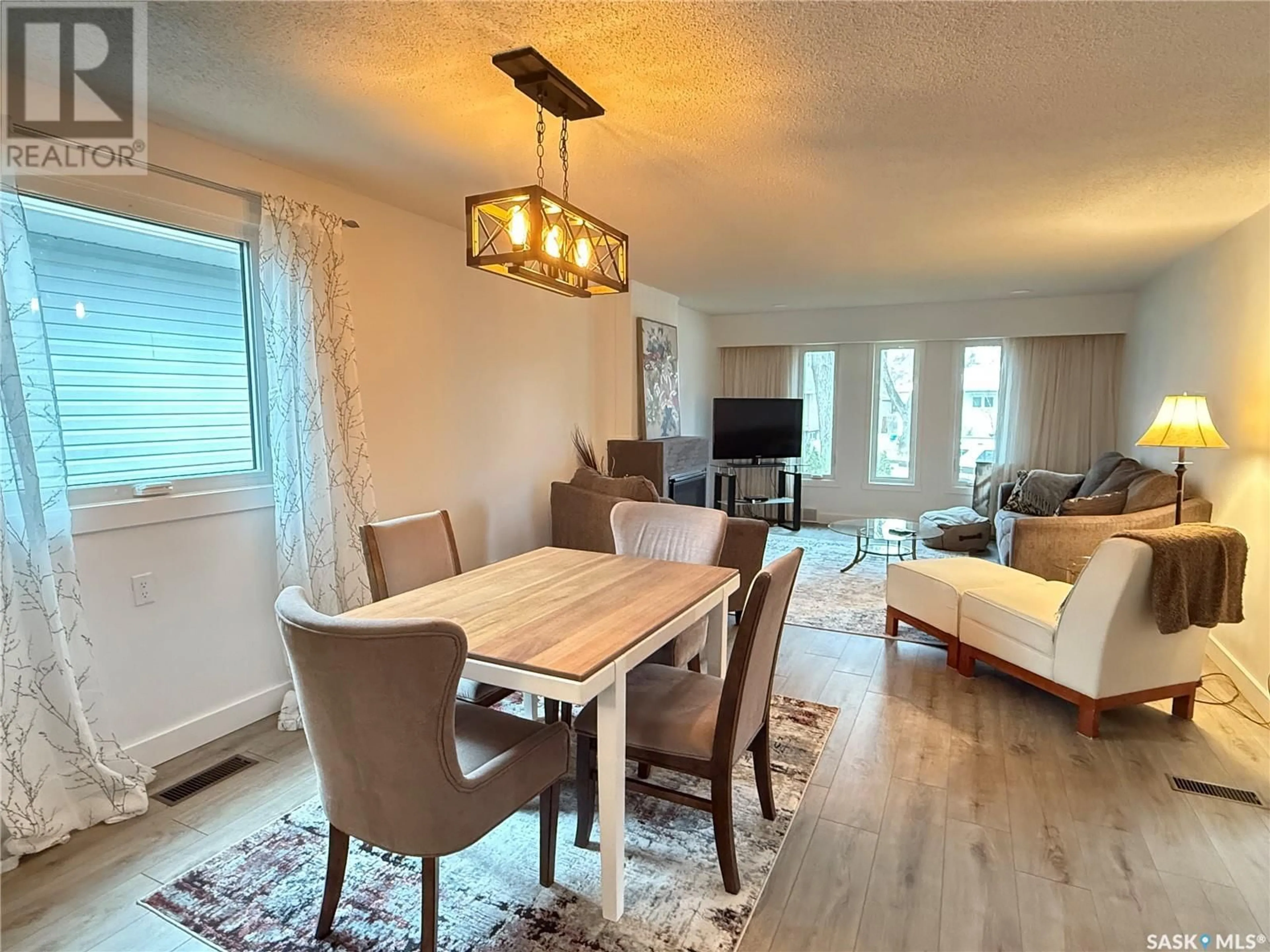 Living room with furniture, wood/laminate floor for 615 WINDSOR STREET, Weyburn Saskatchewan S4H0X1