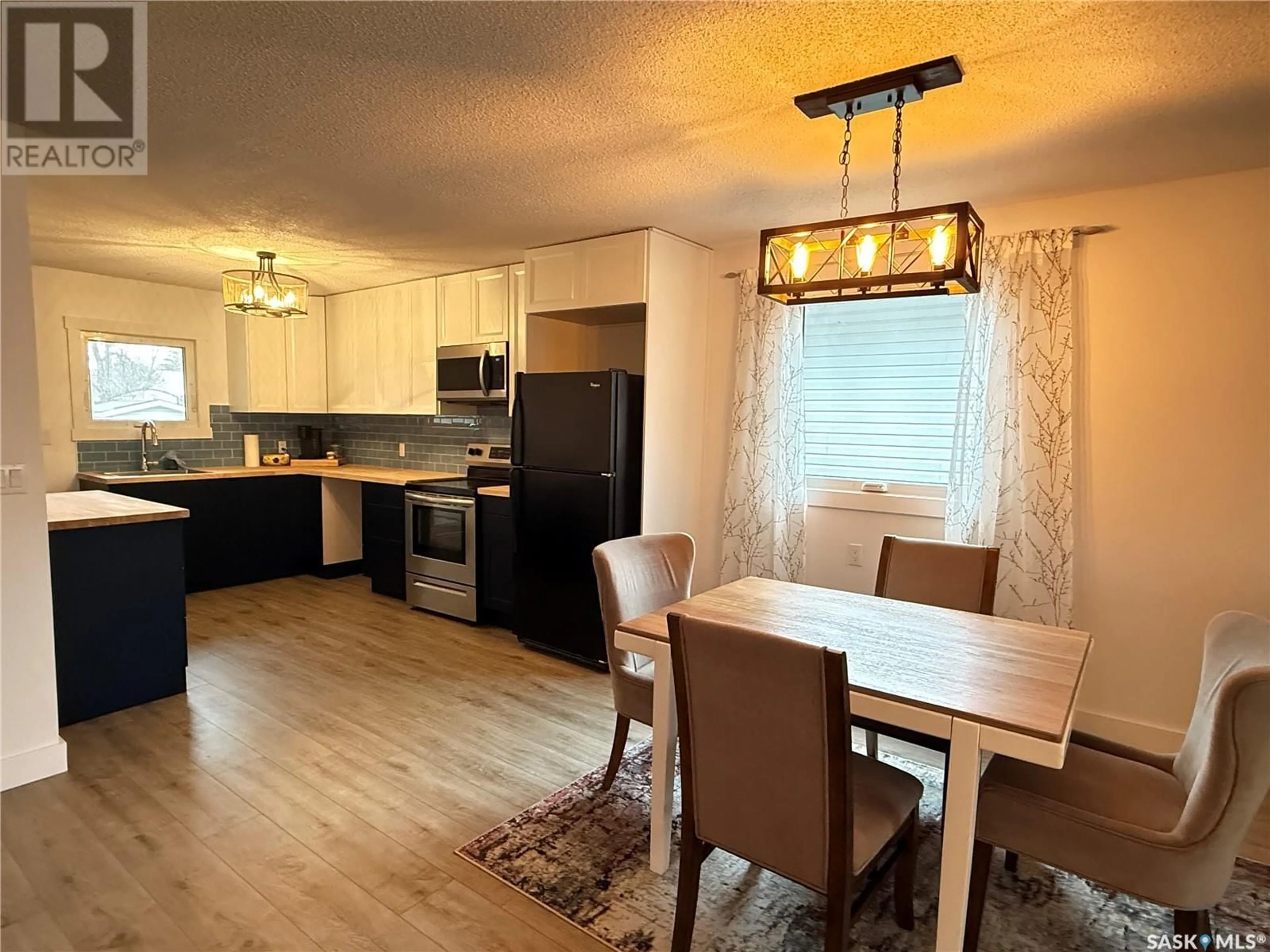 Open concept kitchen, wood/laminate floor for 615 WINDSOR STREET, Weyburn Saskatchewan S4H0X1
