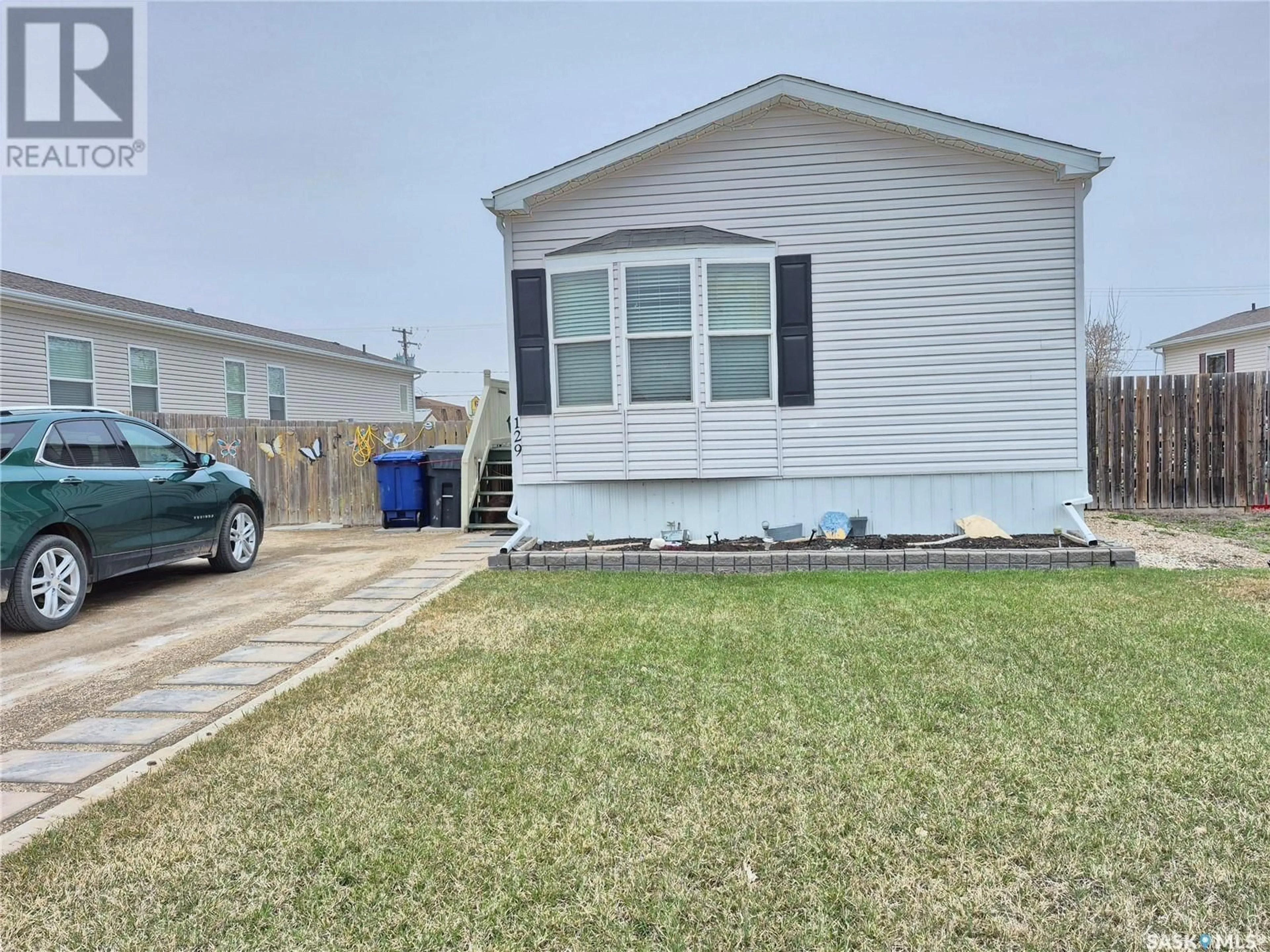 Home with vinyl exterior material, street for 129 1ST AVENUE, Weyburn Saskatchewan S4H2H9