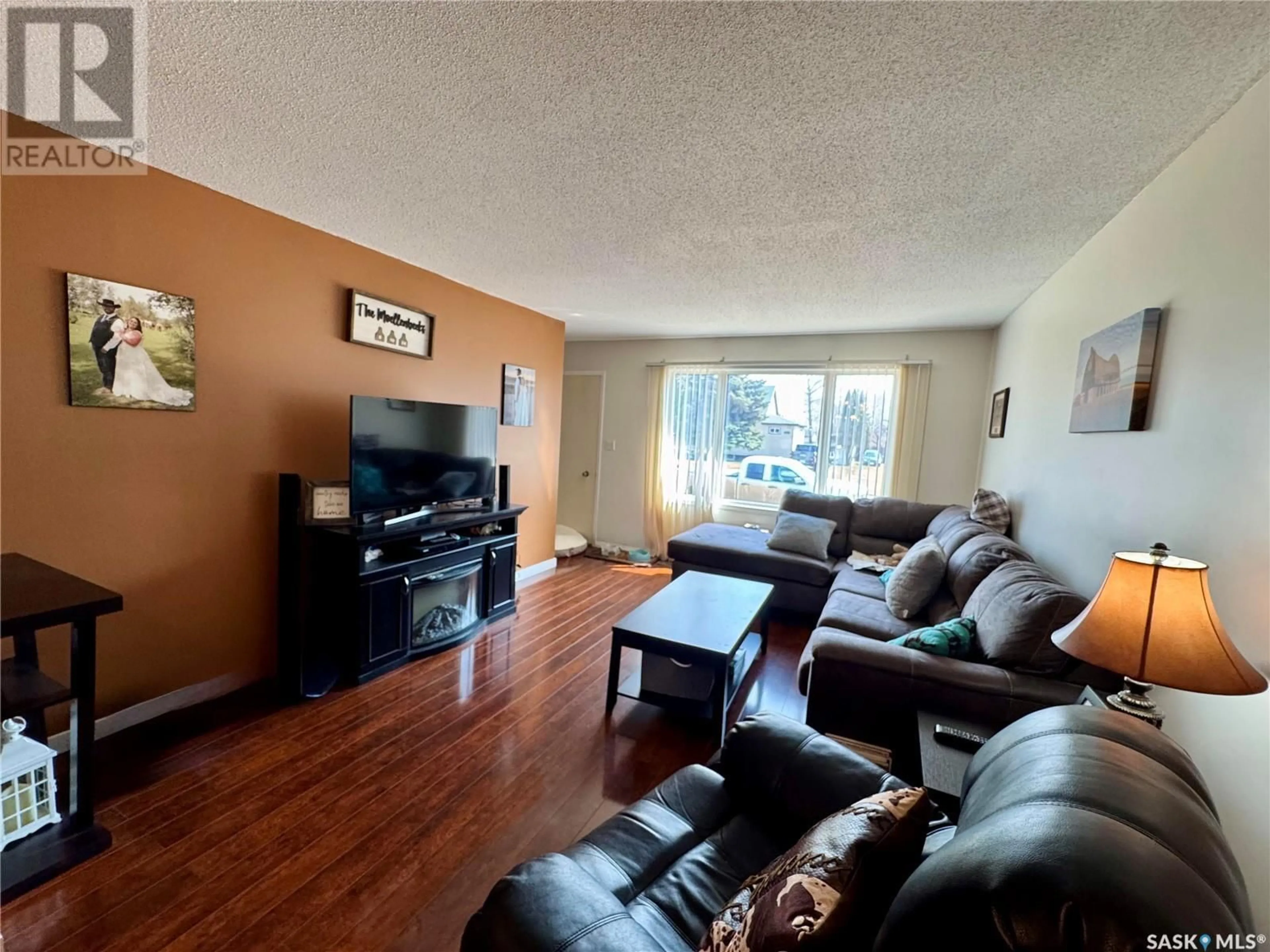 Living room with furniture, wood/laminate floor for 320 1ST AVENUE, Englefeld Saskatchewan S0K1N0