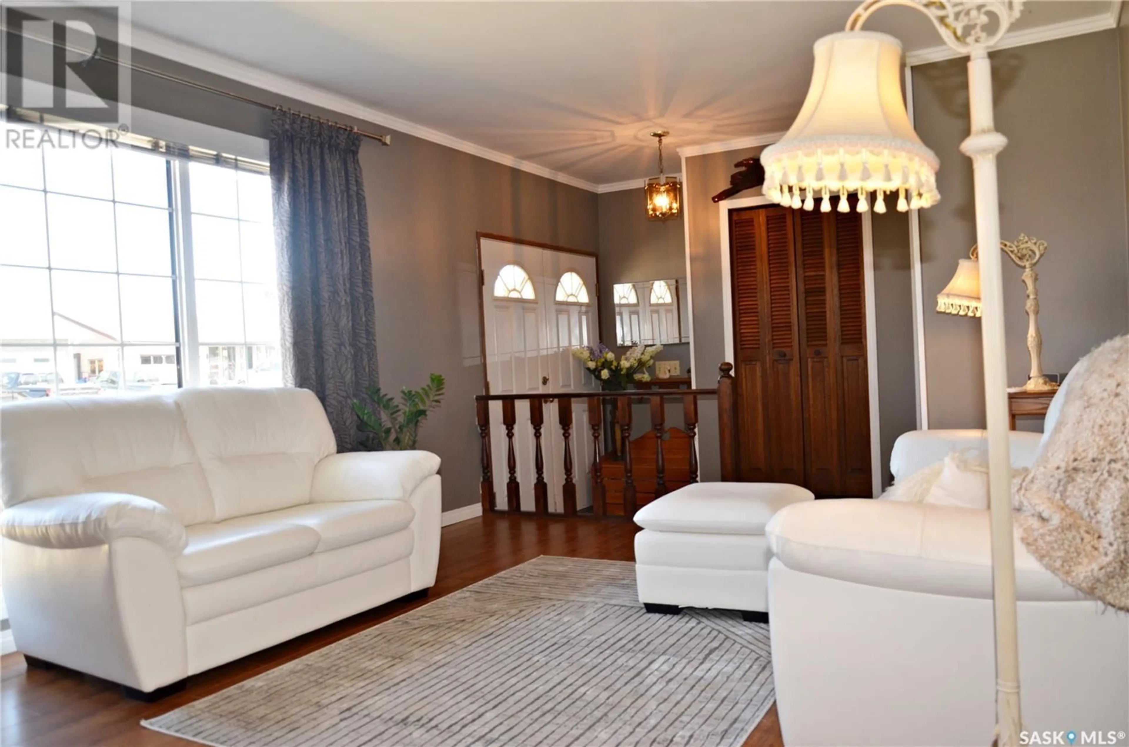 Living room with furniture, wood/laminate floor for 720 PORTAGE AVENUE, Wadena Saskatchewan S0A0C1