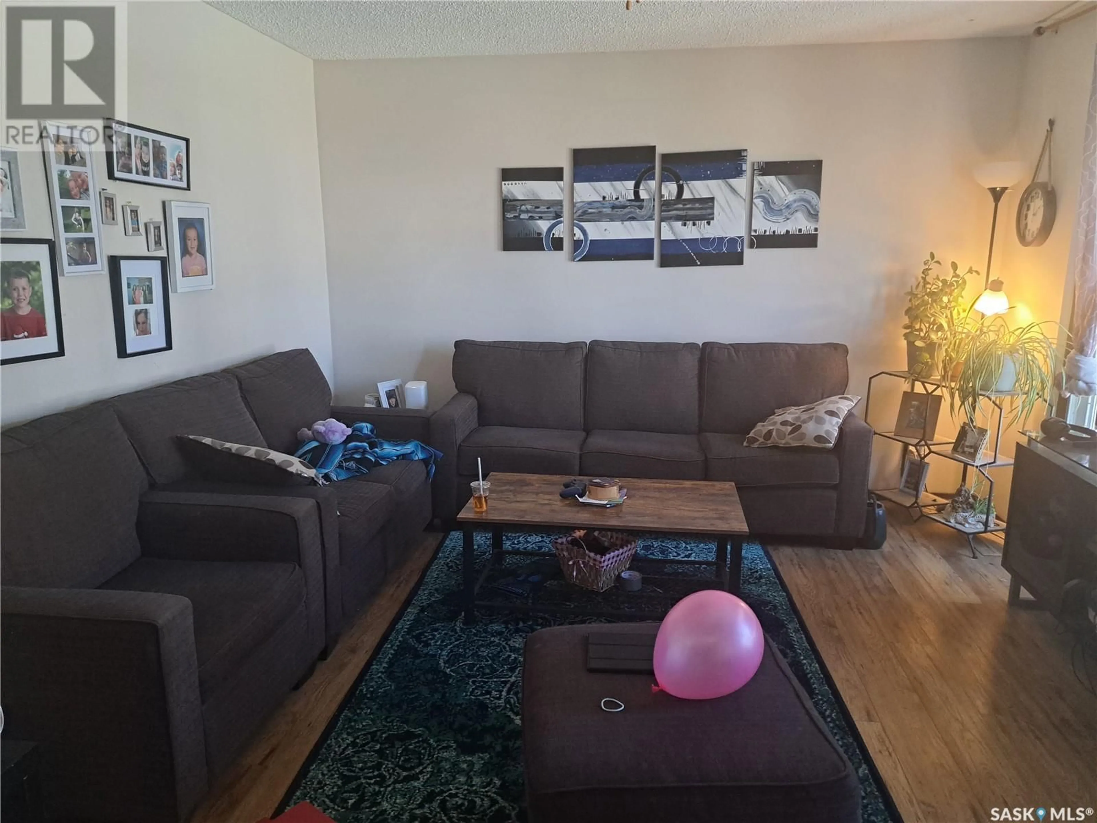 Living room with furniture, wood/laminate floor for 514 HILLIARD STREET, Saskatoon Saskatchewan S7M0G7