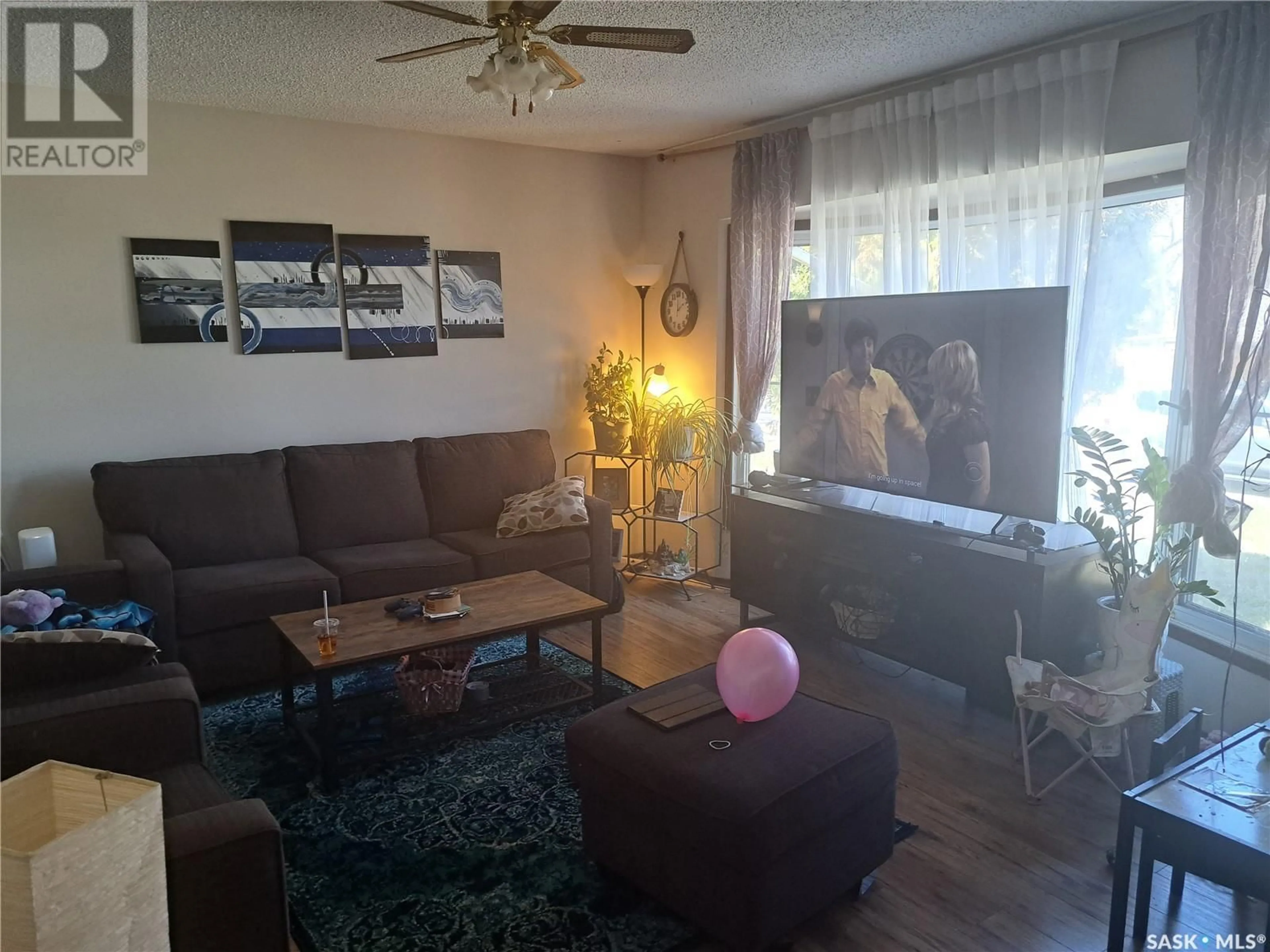 Living room with furniture, wood/laminate floor for 514 HILLIARD STREET, Saskatoon Saskatchewan S7M0G7