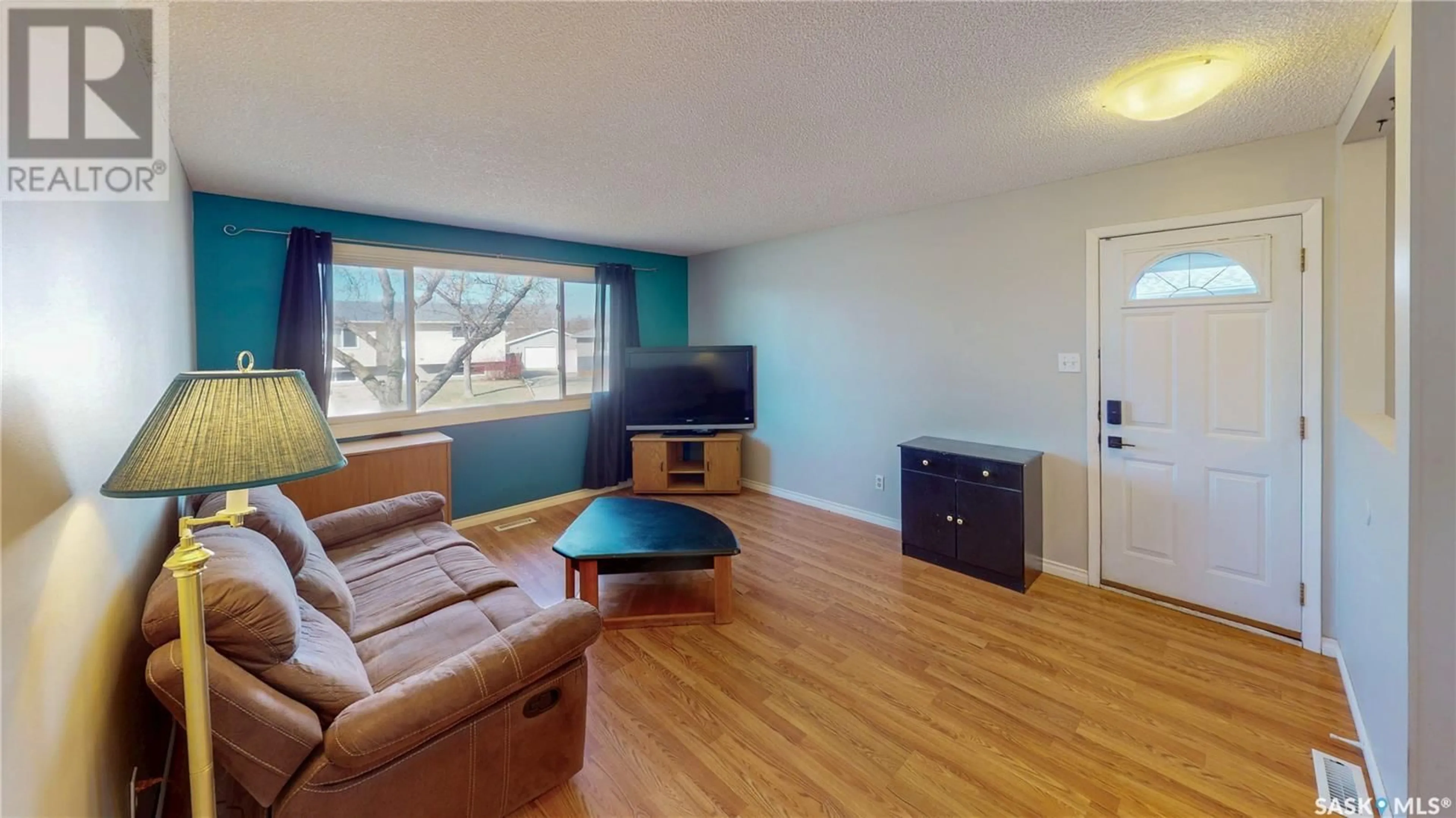 Living room with furniture, wood/laminate floor for 47 LLOYD CRESCENT, Regina Saskatchewan S4R6B8