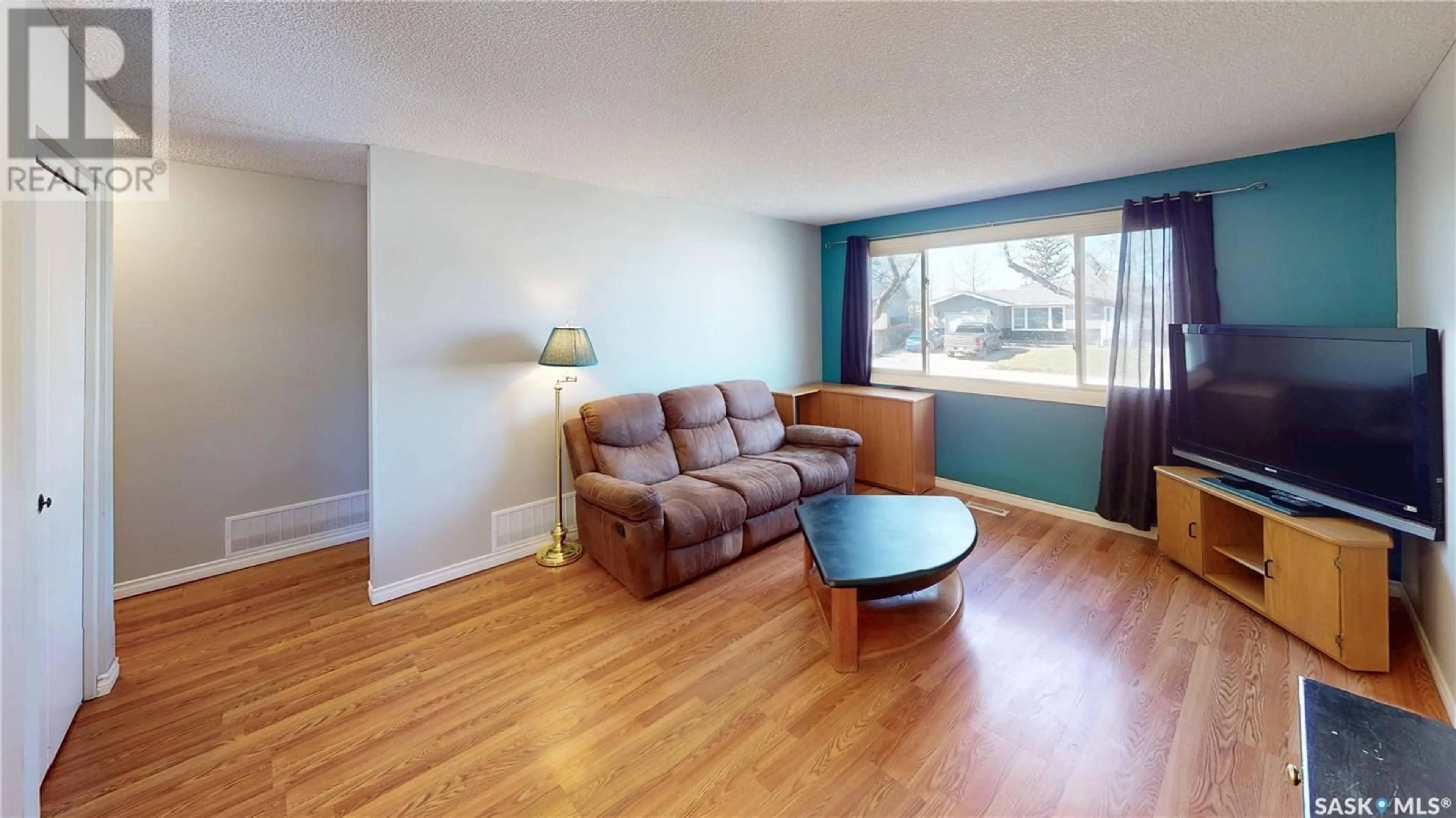 Living room with furniture, wood/laminate floor for 47 LLOYD CRESCENT, Regina Saskatchewan S4R6B8