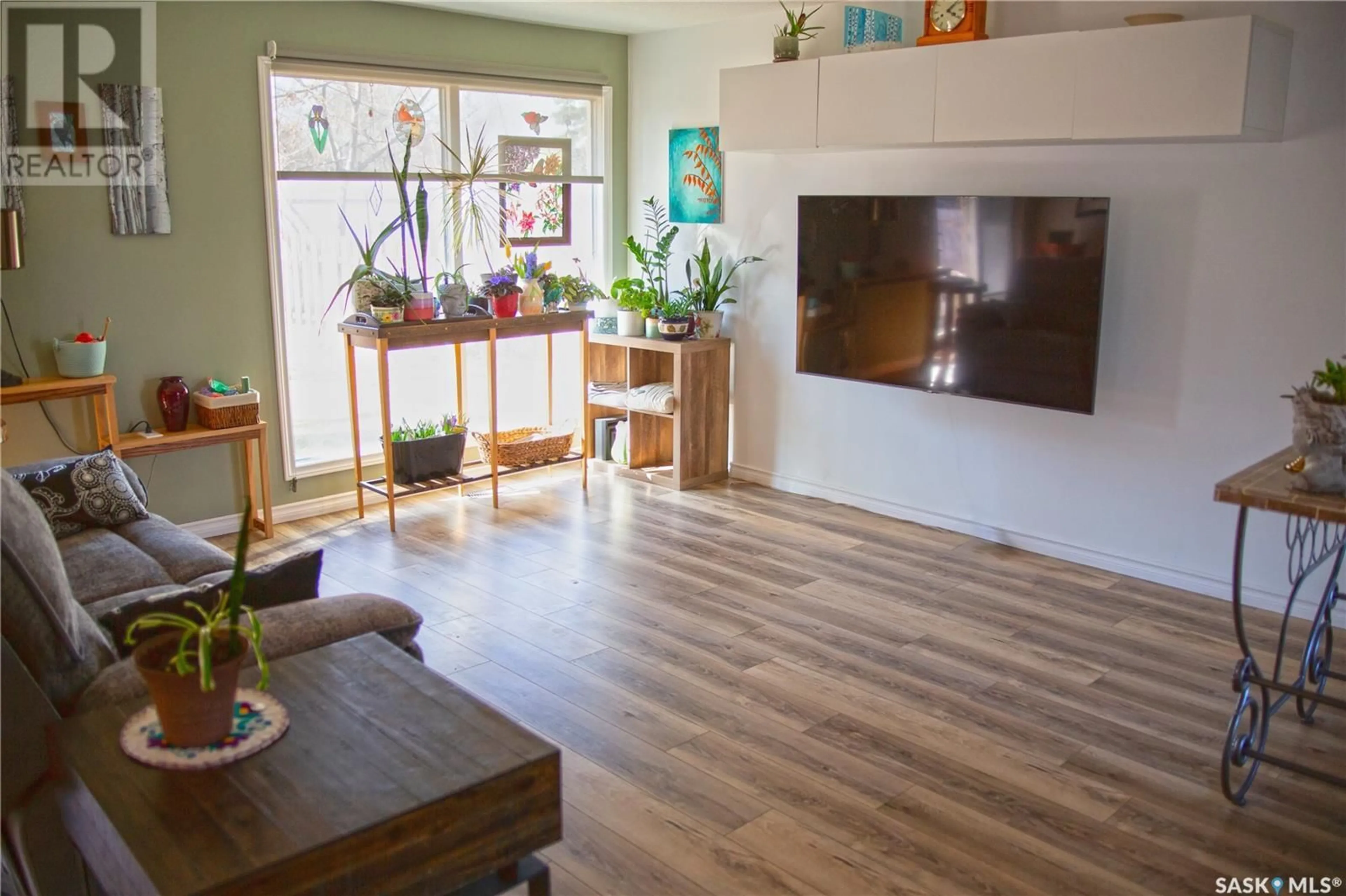 Living room with furniture, wood/laminate floor for 217 10TH AVENUE, Kindersley Saskatchewan S0L1S0
