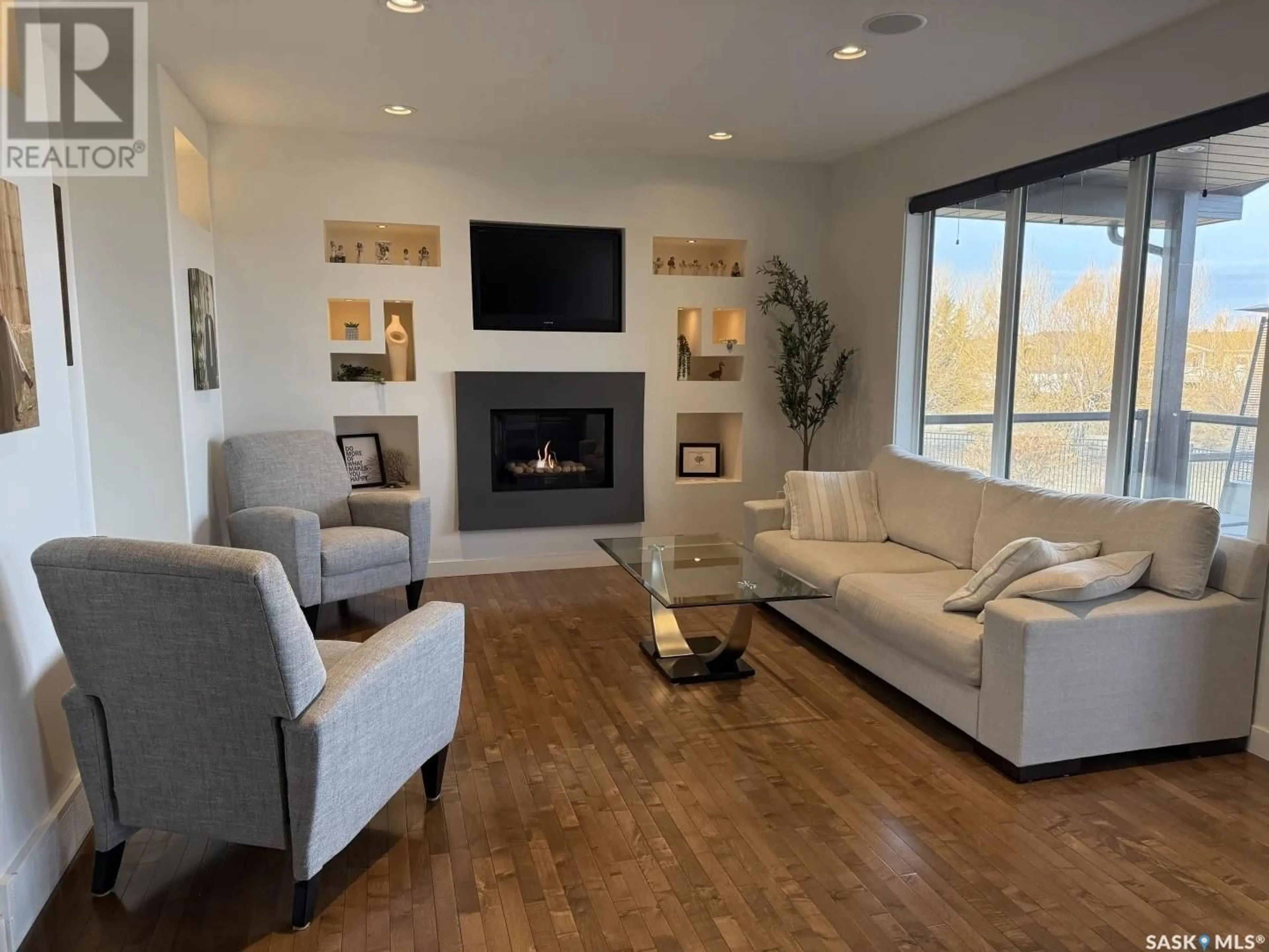 Living room with furniture, wood/laminate floor for 62 ASPEN PLACE, Yorkton Saskatchewan S3N0C5