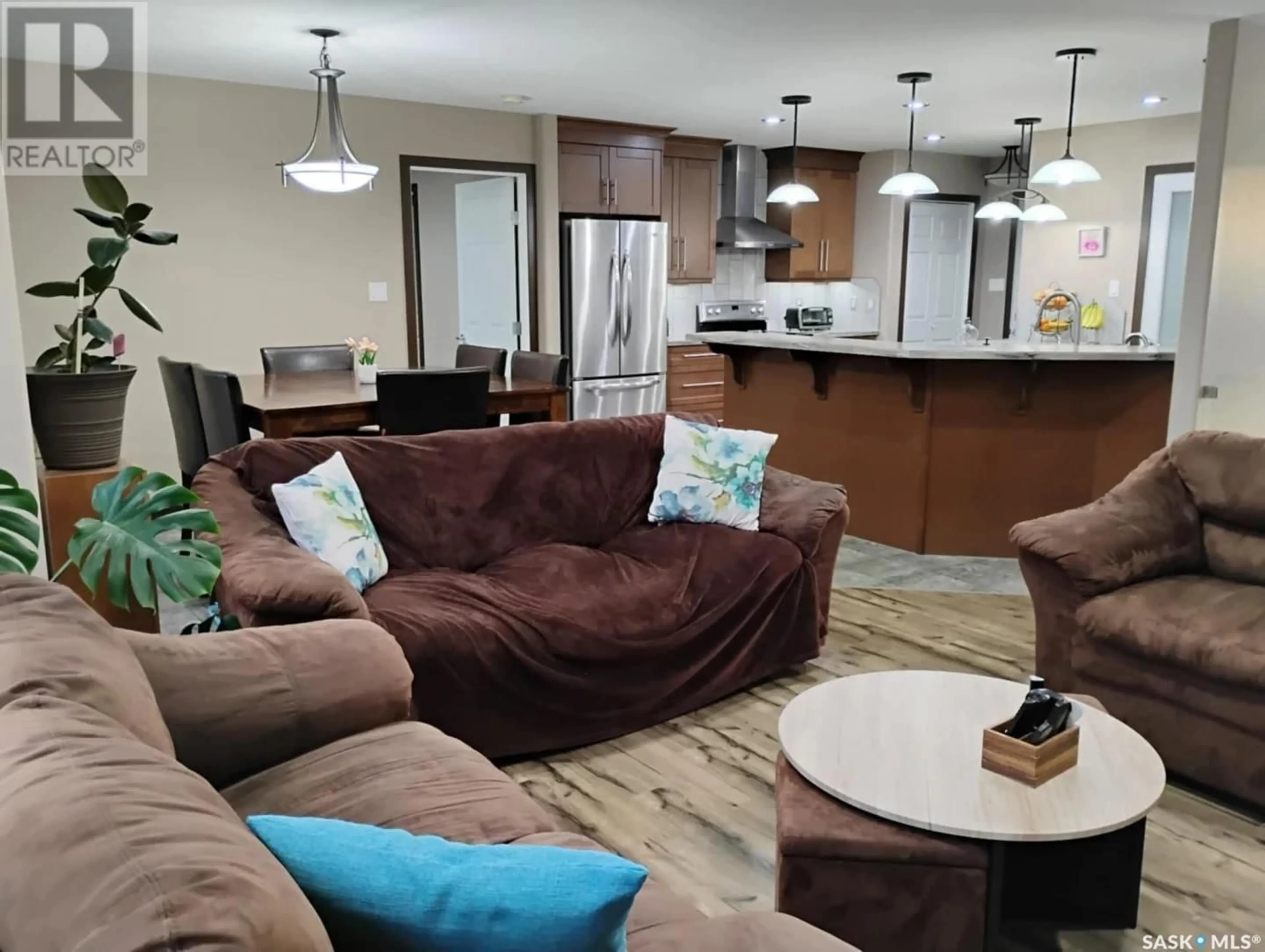 Living room with furniture, wood/laminate floor for 309 DOUGLAS AVENUE, Orkney Rm No. 244 Saskatchewan S3N4K1