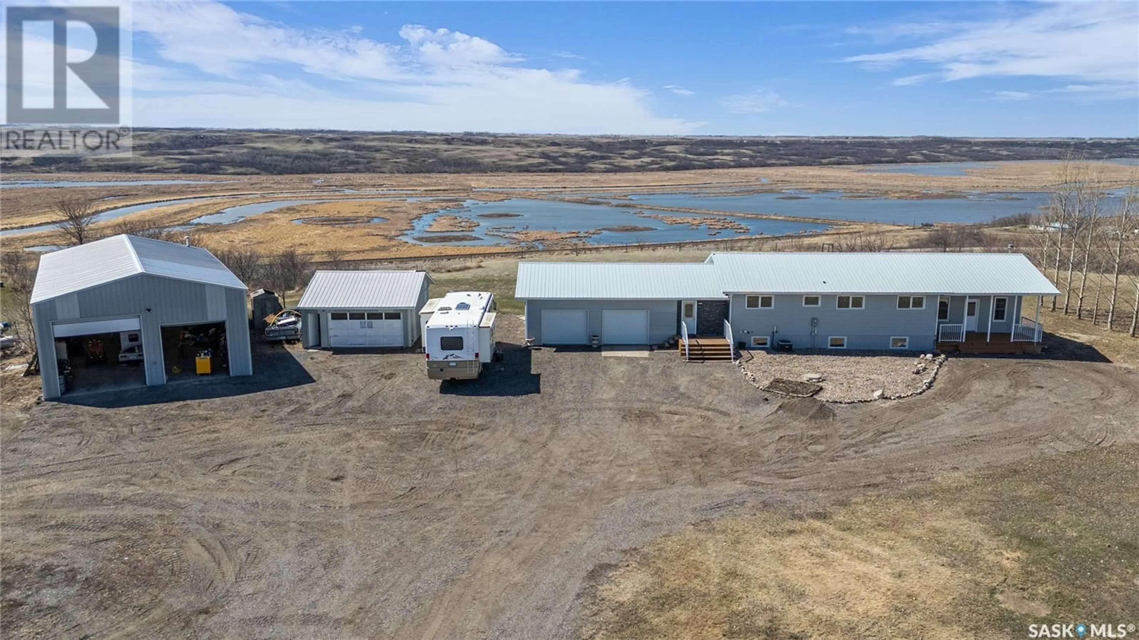 A pic from outside/outdoor area/front of a property/back of a property/a pic from drone, water/lake/river/ocean view for 13 CUMMINS ROAD, Longlaketon Rm No. 219 Saskatchewan S0G0W0