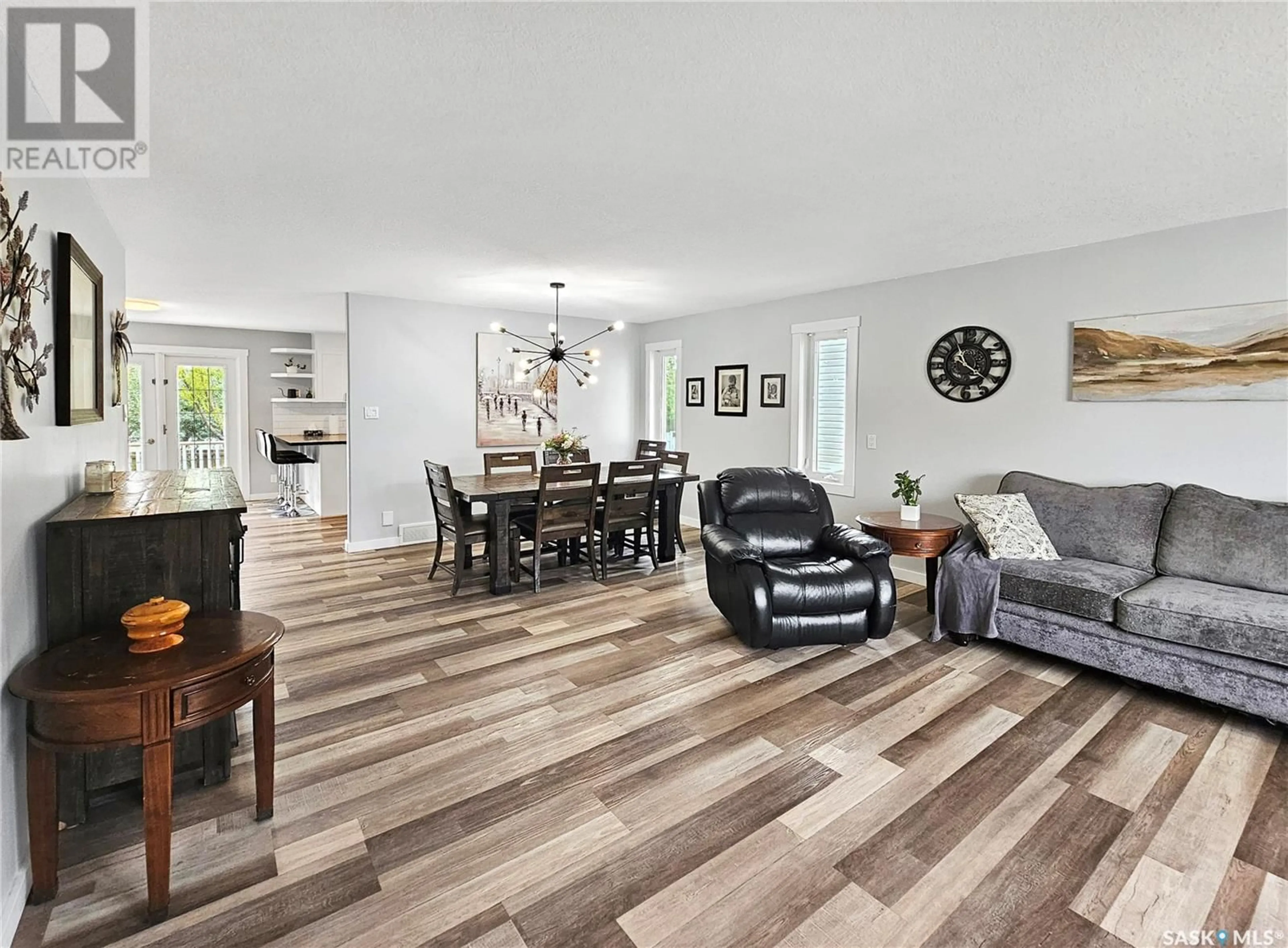 Living room with furniture, wood/laminate floor for 519 PALLISER DRIVE, Swift Current Saskatchewan S9H5C5