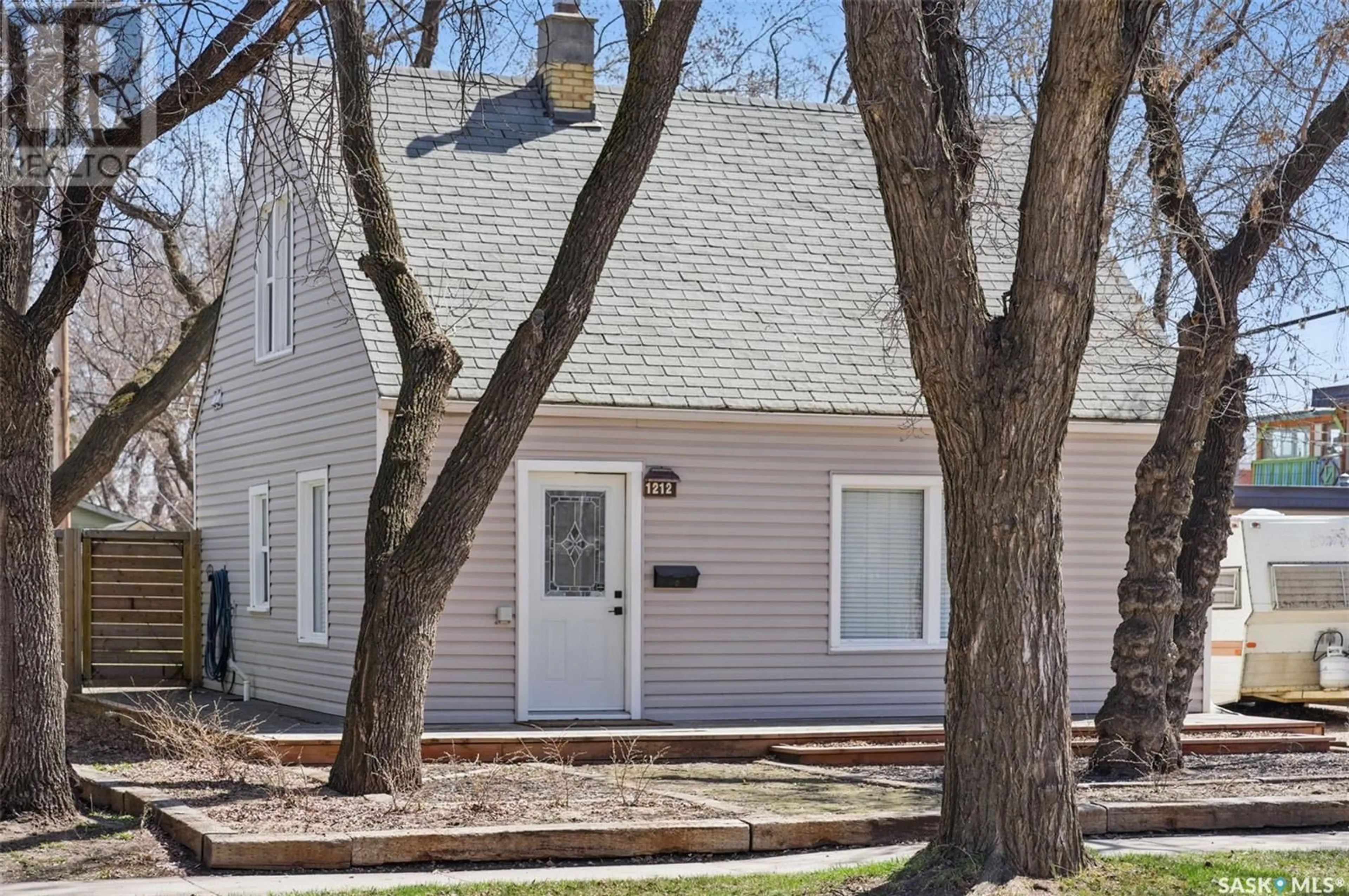 Home with vinyl exterior material, street for 1212 F AVENUE, Saskatoon Saskatchewan S7L1X3