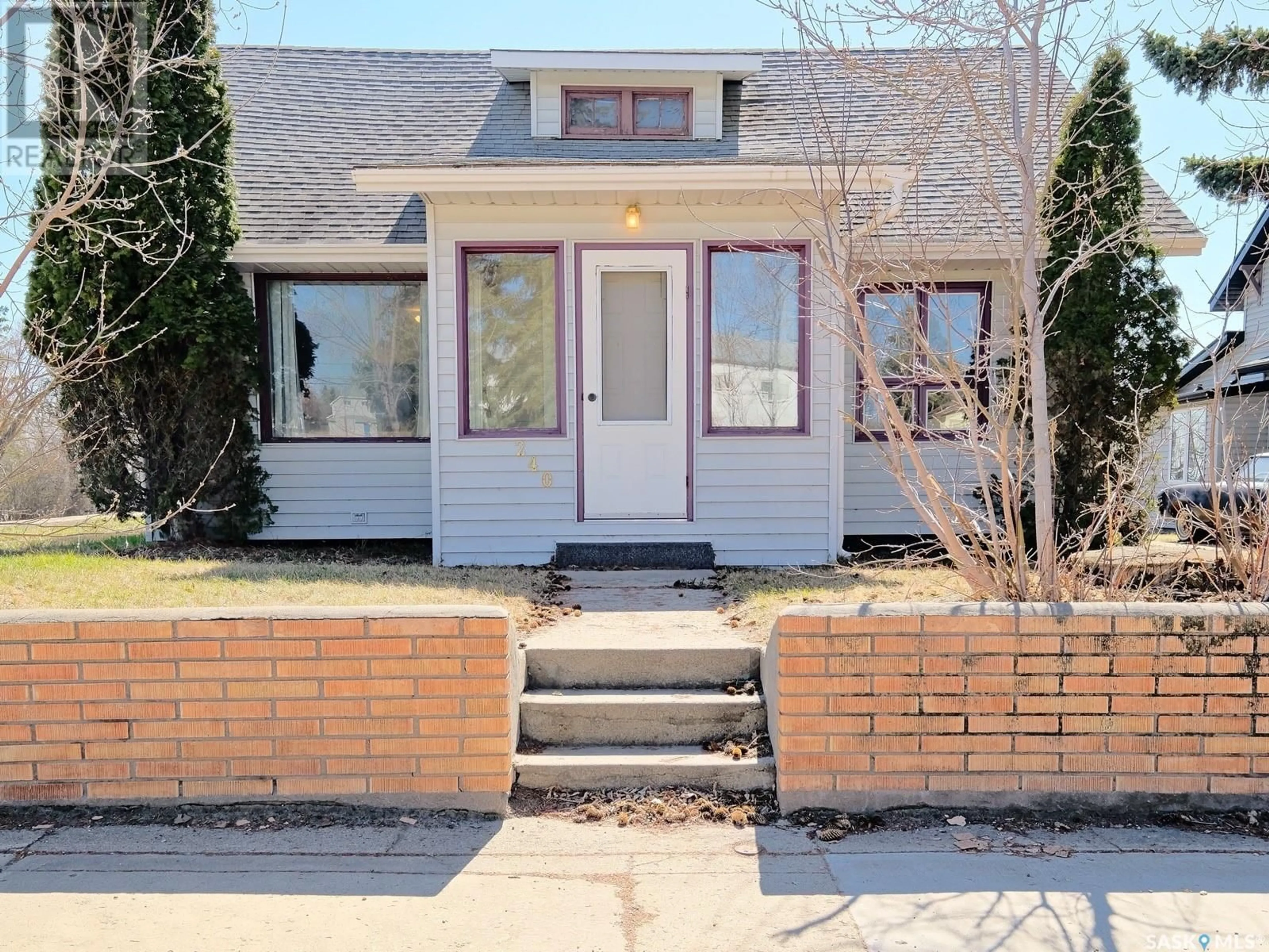 Home with brick exterior material, street for 240 3RD AVENUE, Biggar Saskatchewan S0L2V0