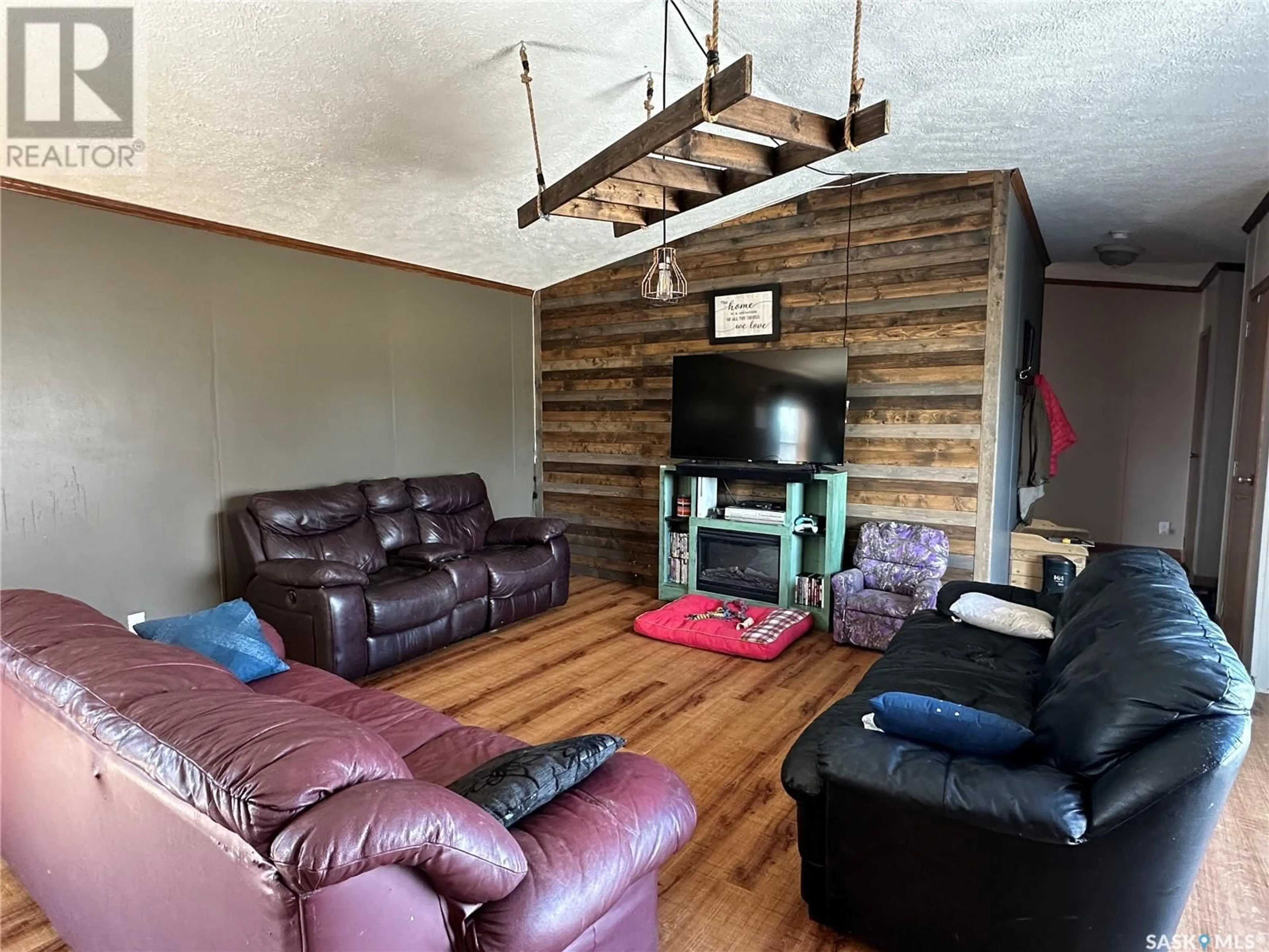 Living room with furniture, wood/laminate floor for 201 MAIN STREET, Griffin Saskatchewan S0C1G0