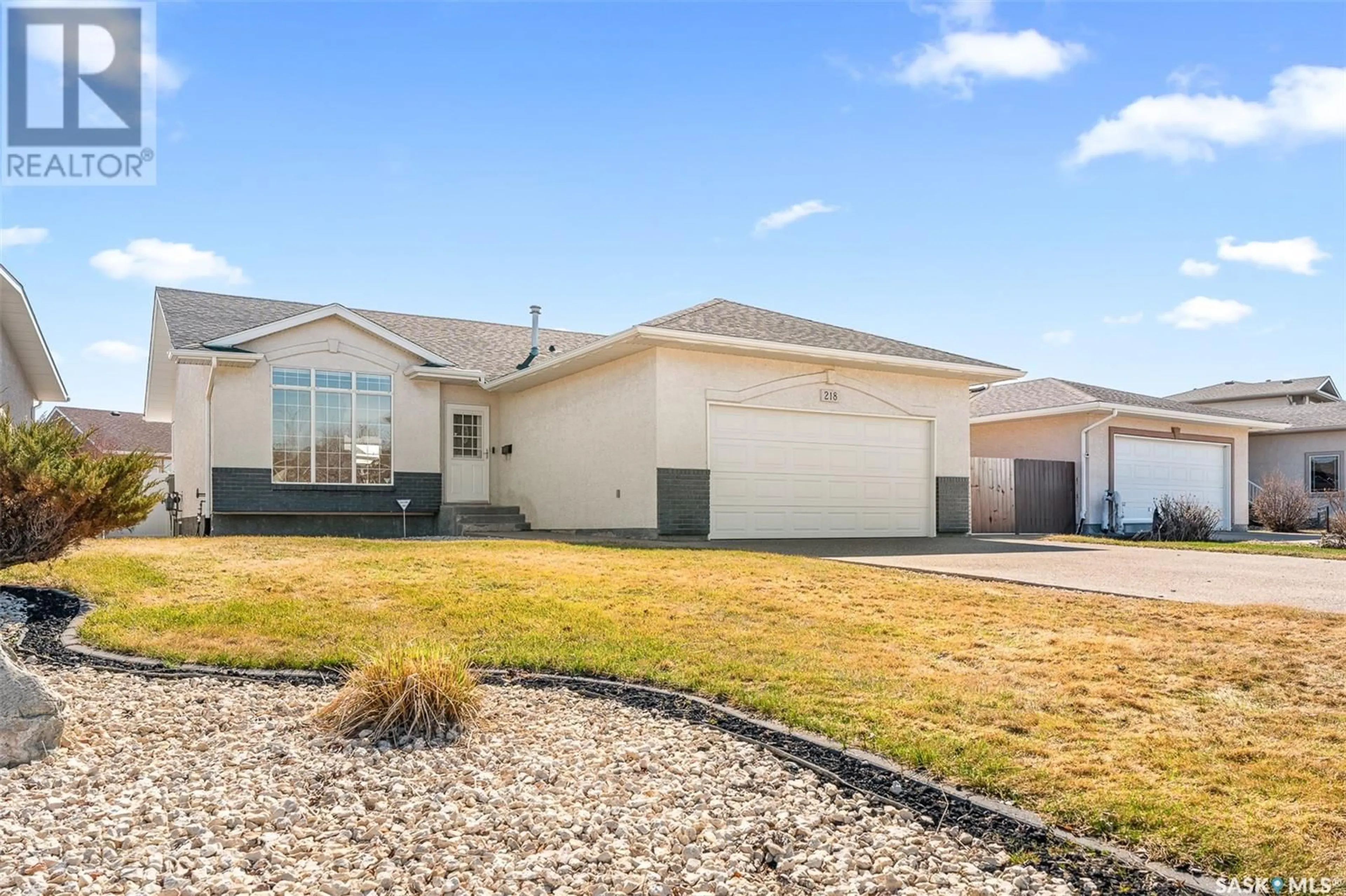 Home with vinyl exterior material, street for 218 BLUE SAGE DRIVE, Moose Jaw Saskatchewan S6J1L1