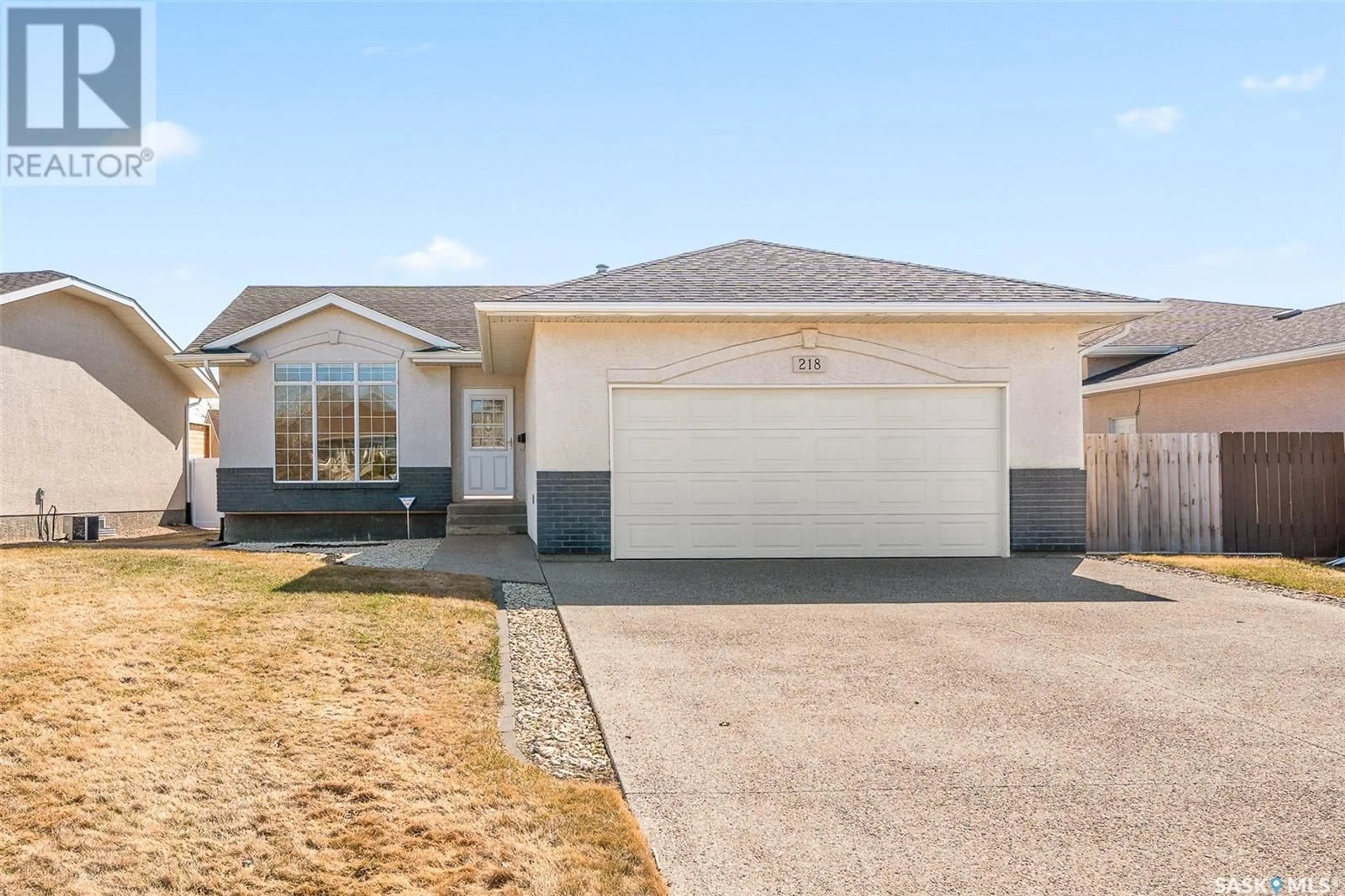 Home with vinyl exterior material, street for 218 BLUE SAGE DRIVE, Moose Jaw Saskatchewan S6J1L1
