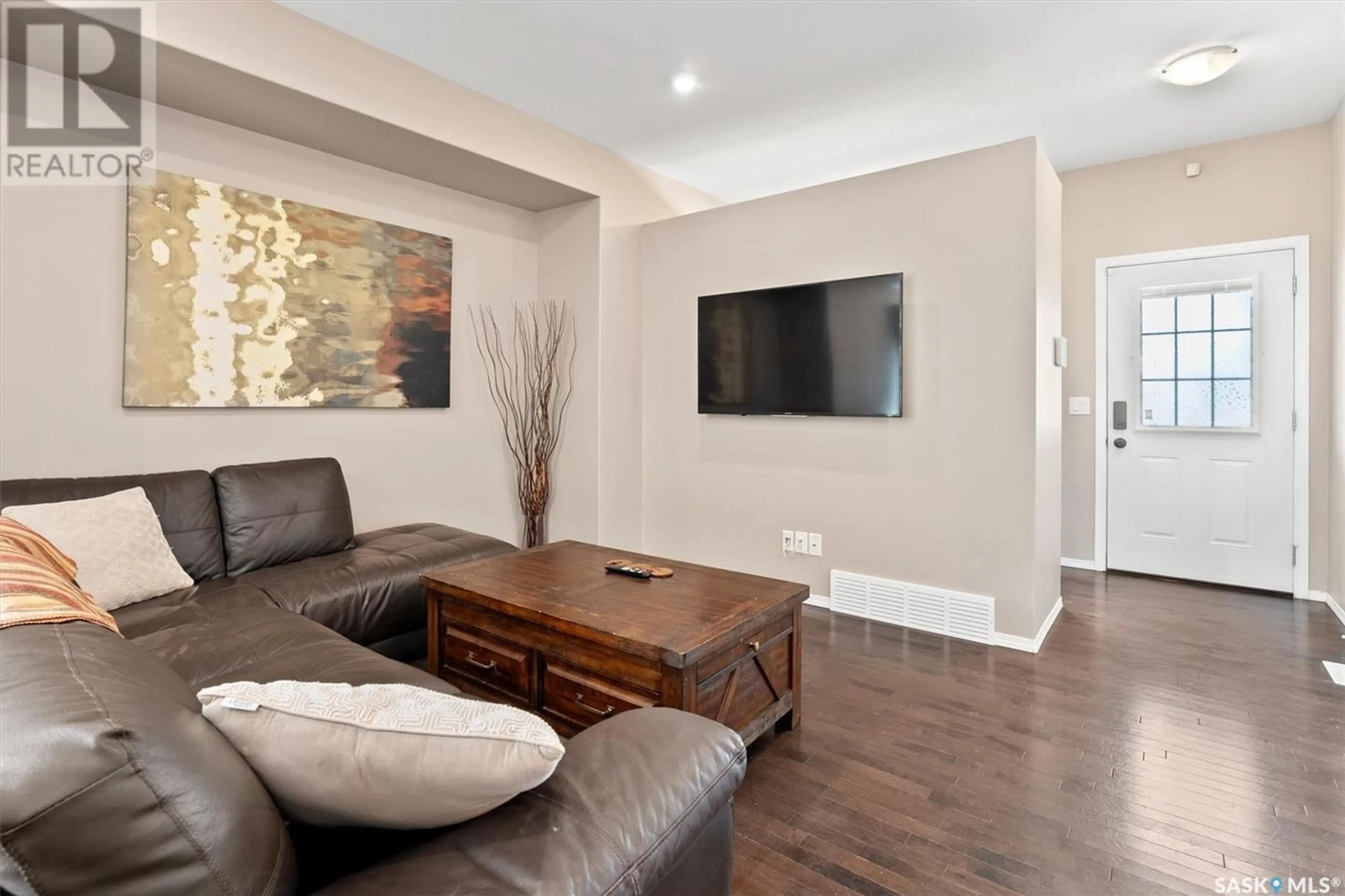 Living room with furniture, wood/laminate floor for 431 PRITCHARD LANE, Saskatoon Saskatchewan S7V0E8