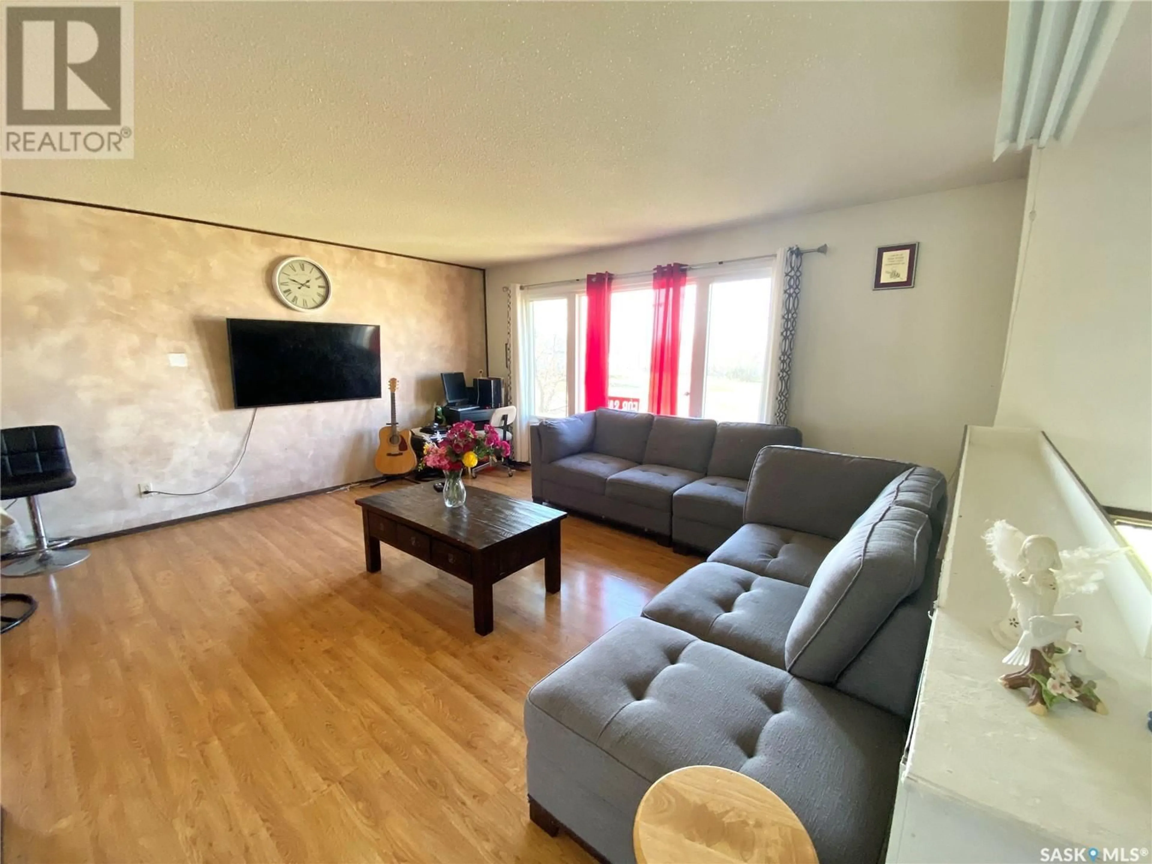 Living room with furniture, wood/laminate floor for 209 3RD AVENUE, Frontier Saskatchewan S0N0W0