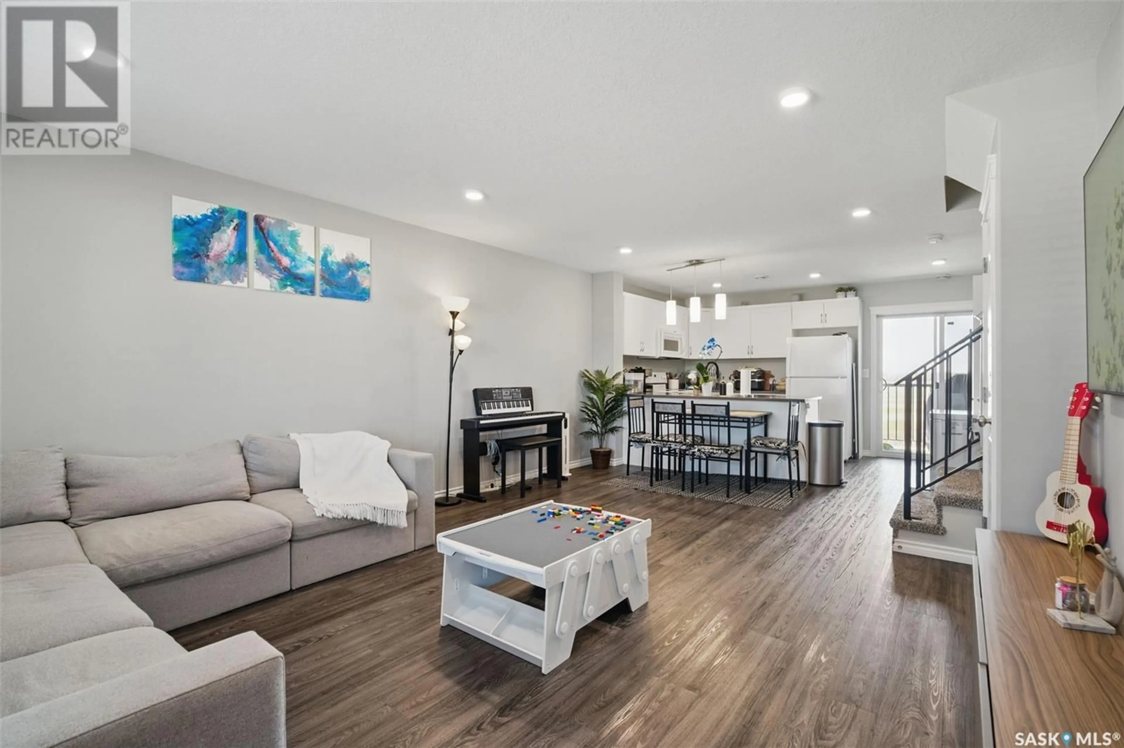 Open concept kitchen, wood/laminate floor for 110 - 309 AKHTAR BEND, Saskatoon Saskatchewan S7W0Y9