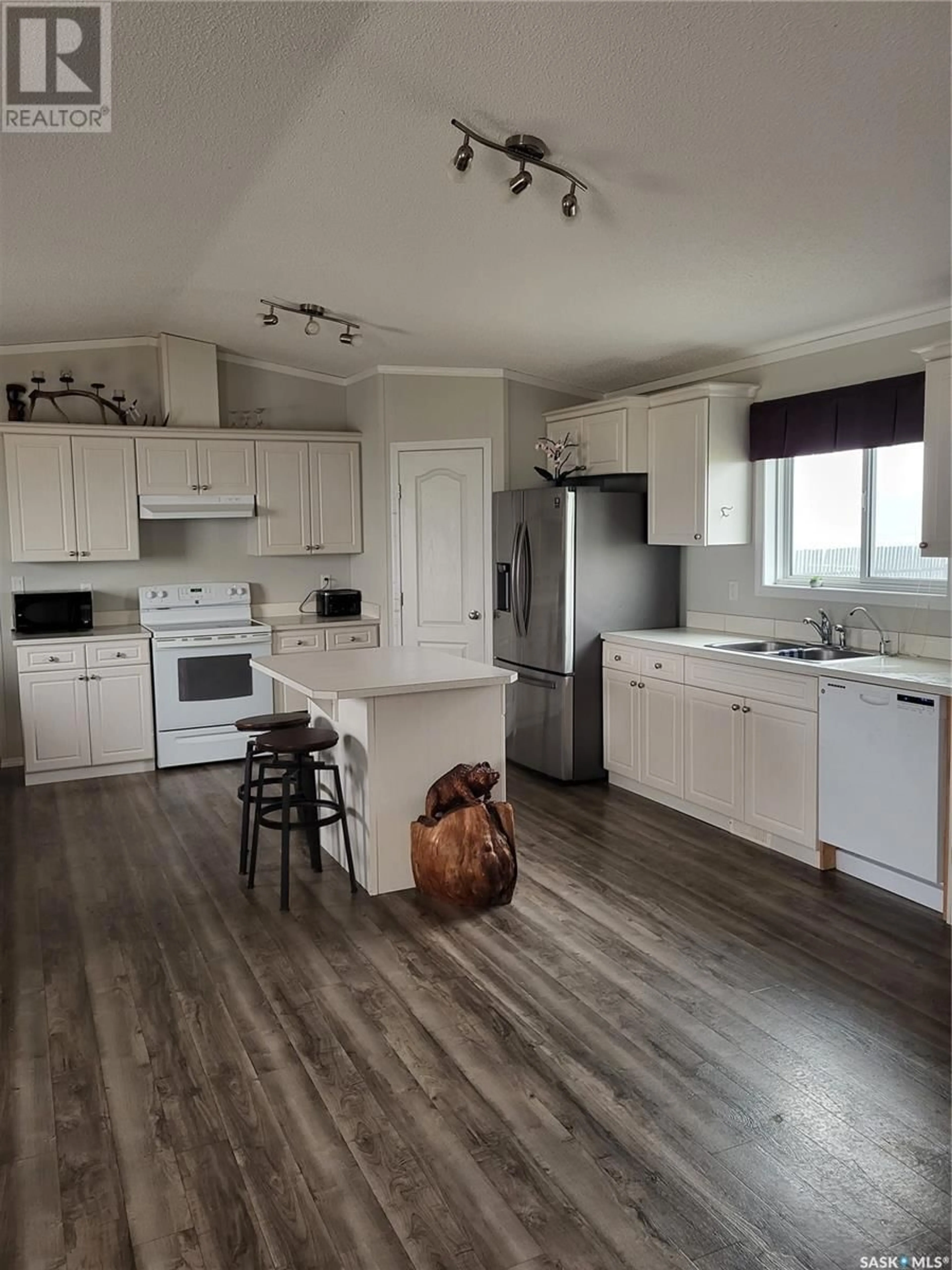 Open concept kitchen, wood/laminate floor for BONYAI WHITFORD ACREAGE, Duck Lake Rm No. 463 Saskatchewan S0K1J0