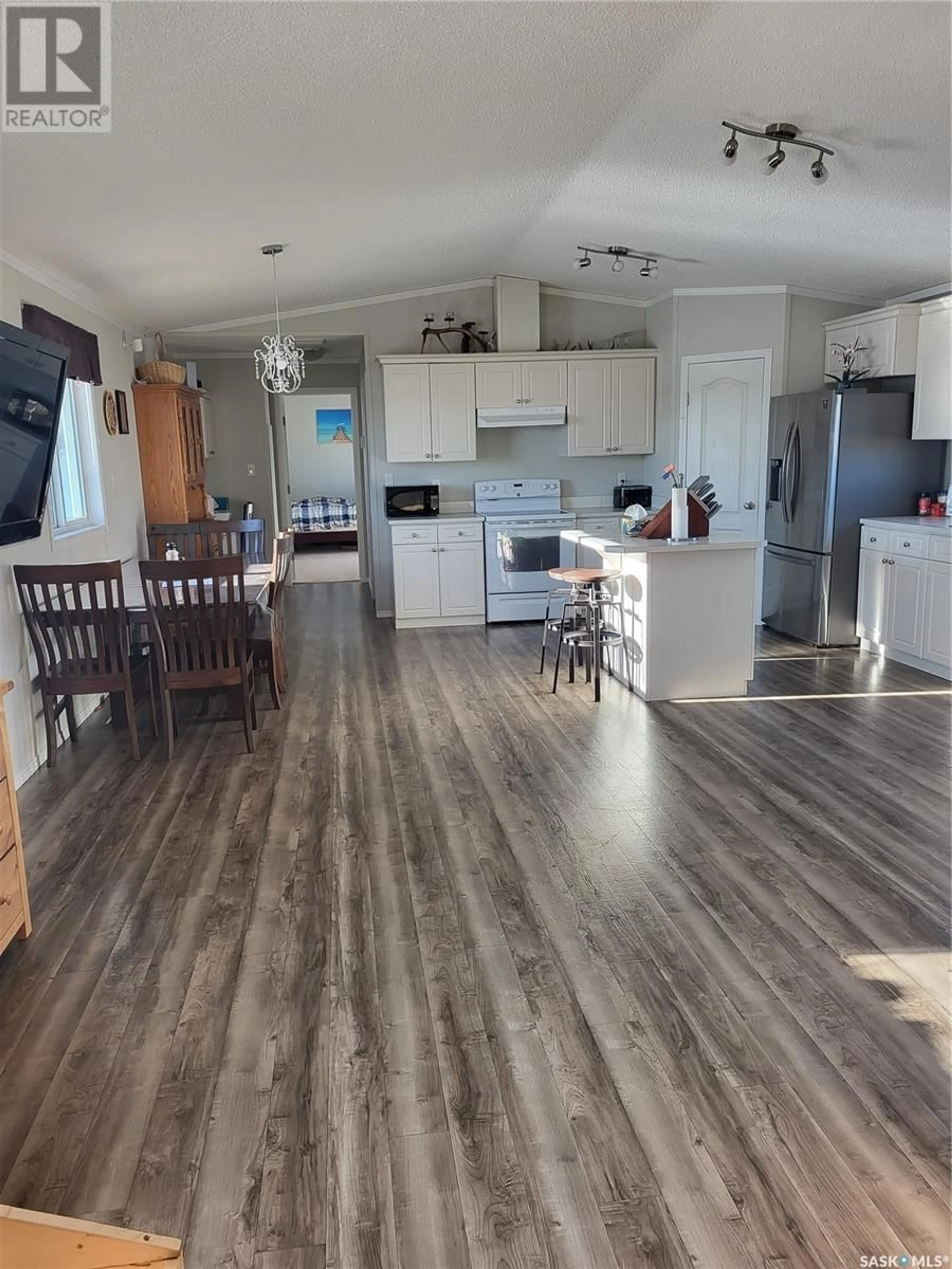 Open concept kitchen, wood/laminate floor for BONYAI WHITFORD ACREAGE, Duck Lake Rm No. 463 Saskatchewan S0K1J0