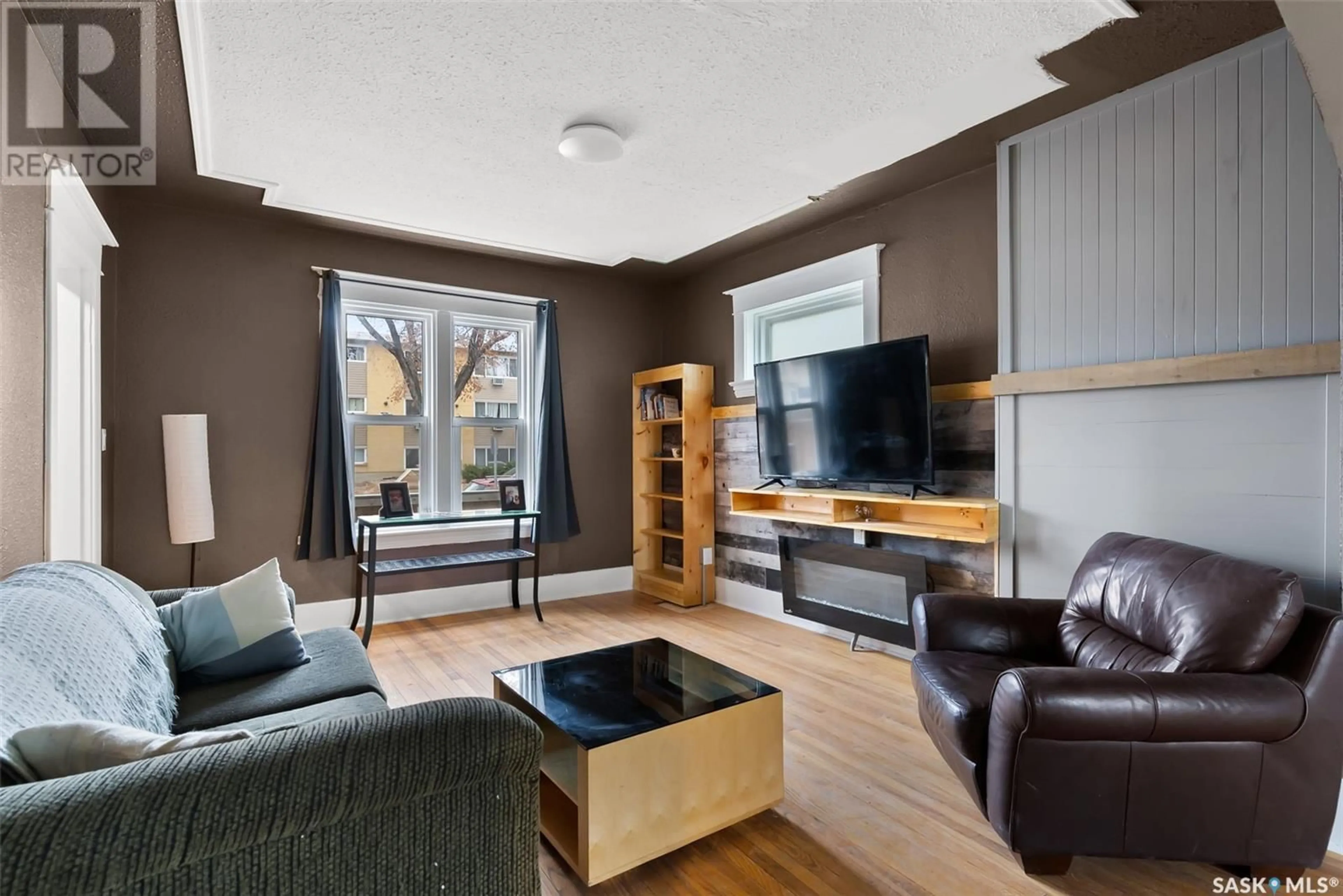 Living room with furniture, wood/laminate floor for 2108 RAE STREET, Regina Saskatchewan S4T2E7