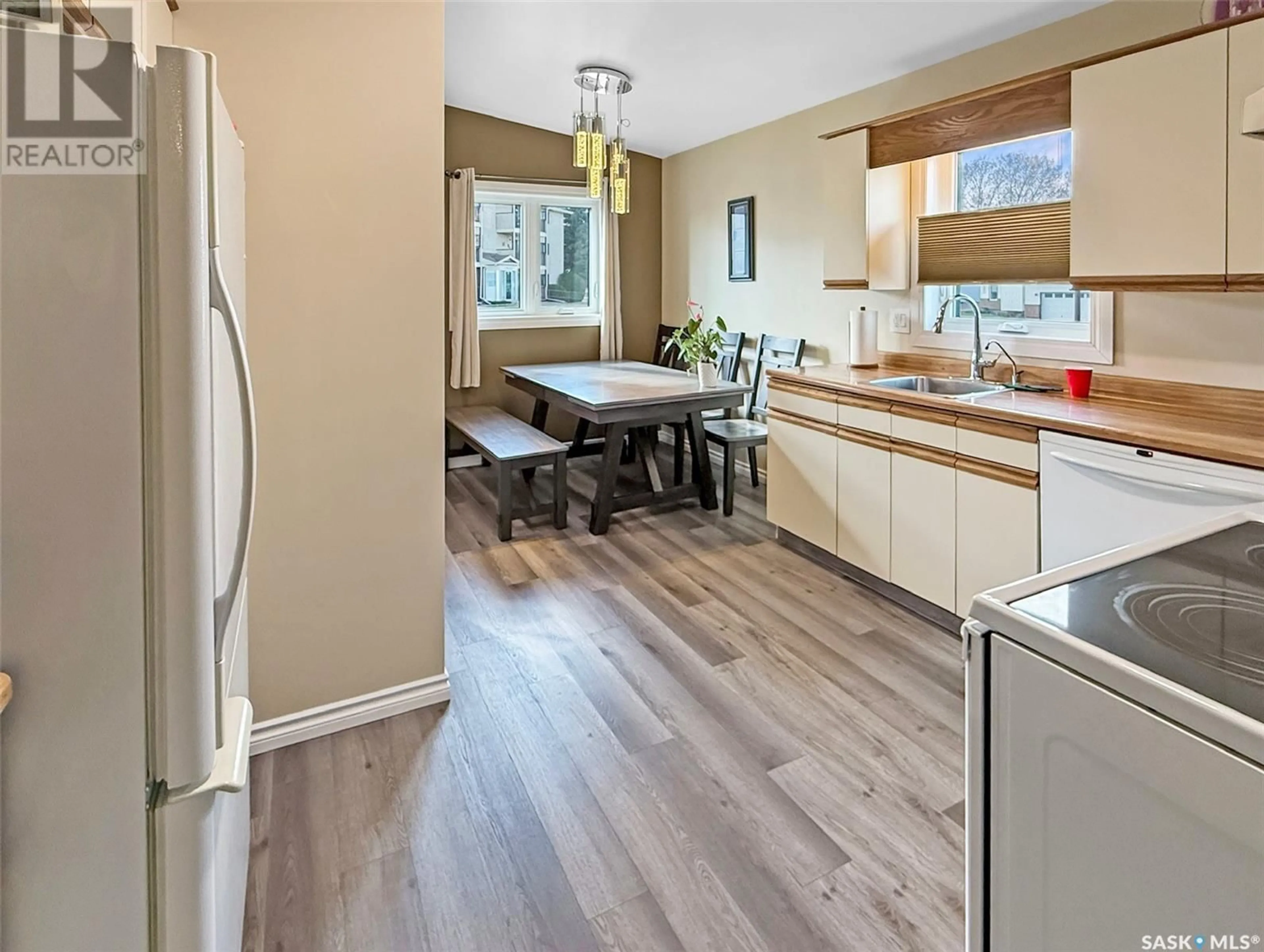 Open concept kitchen, wood/laminate floor for 360 COWIE CRESCENT, Swift Current Saskatchewan S9H4S2