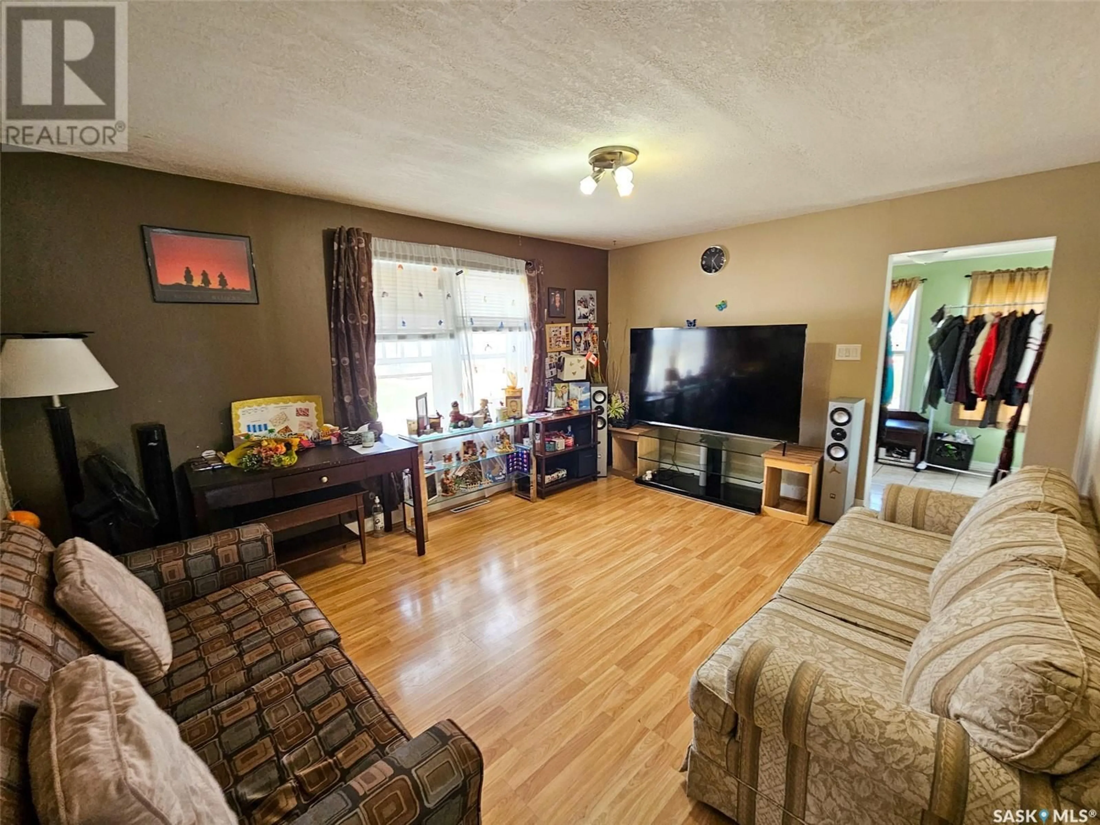 Living room with furniture, wood/laminate floor for 376 4TH AVENUE, Swift Current Saskatchewan S9H0V2