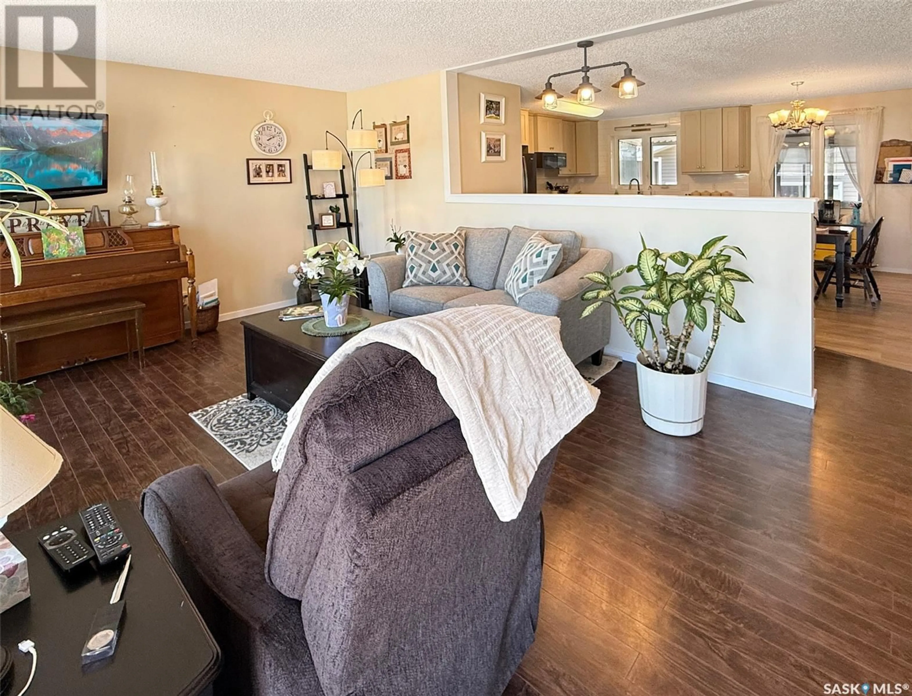 Living room with furniture, wood/laminate floor for 246 5TH AVENUE, Swift Current Saskatchewan S9H3N1