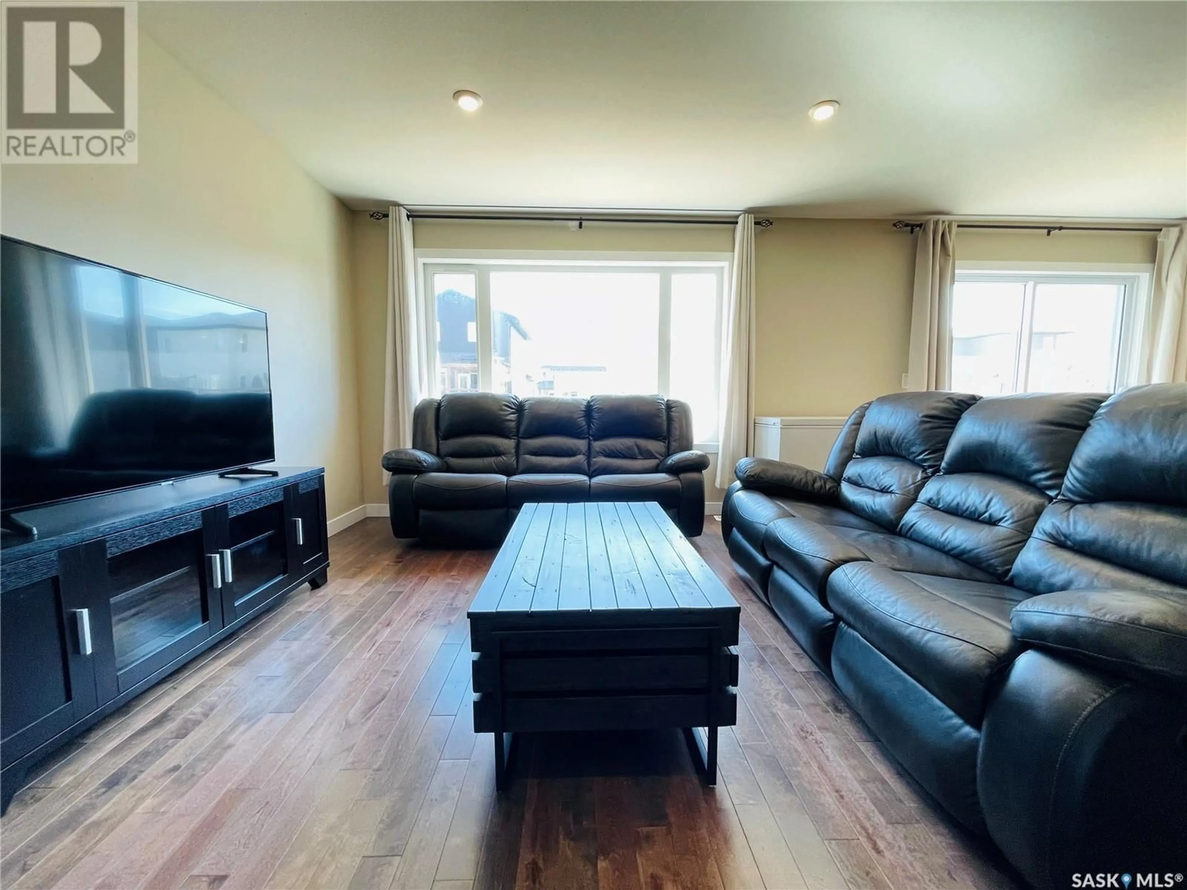 Living room with furniture, wood/laminate floor for 5657 PEARSALL CRESCENT, Regina Saskatchewan S4W0K2
