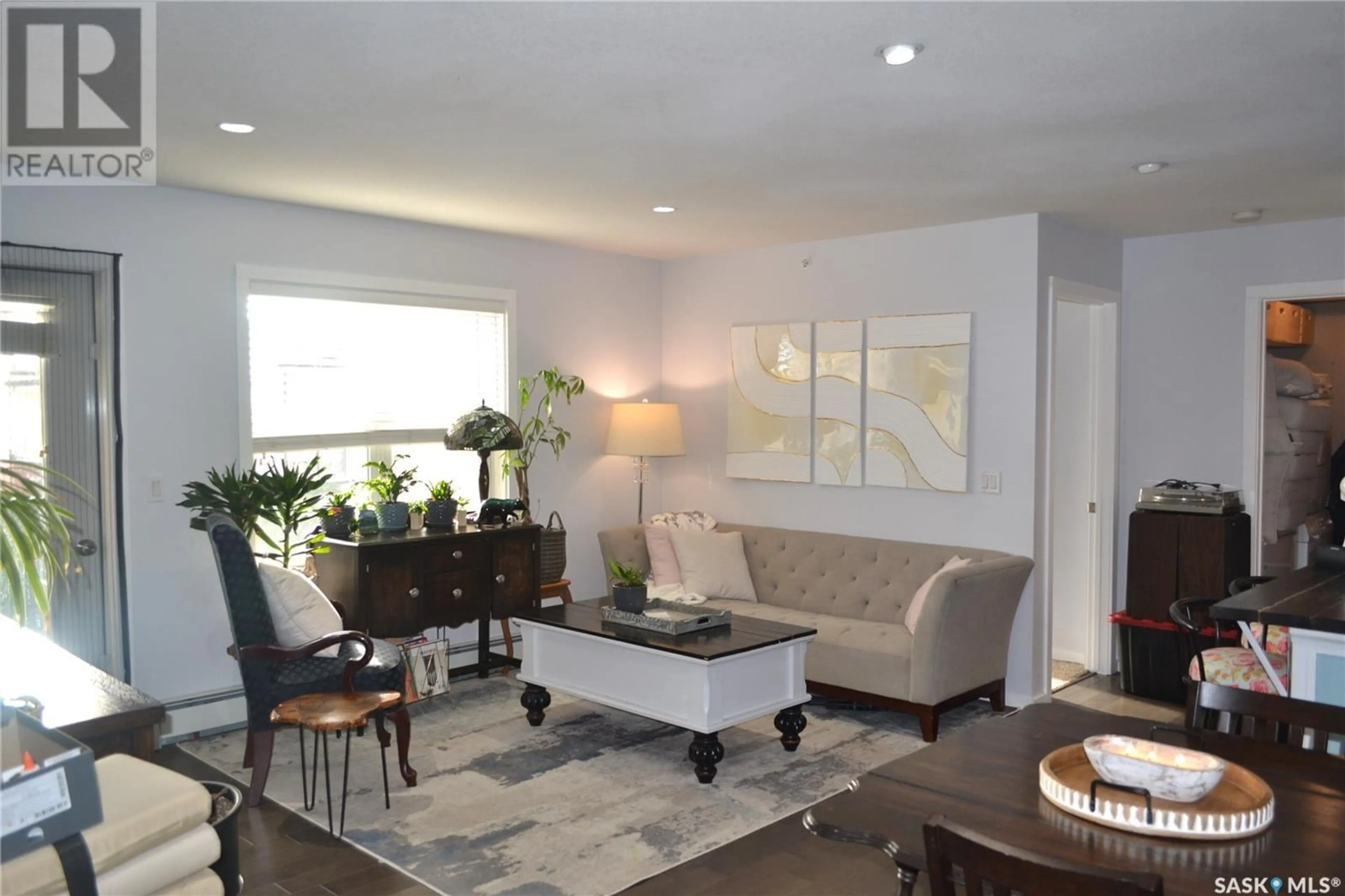 Living room with furniture, wood/laminate floor for 230 - 406 SLIMMON ROAD, Saskatoon Saskatchewan S7V0B3