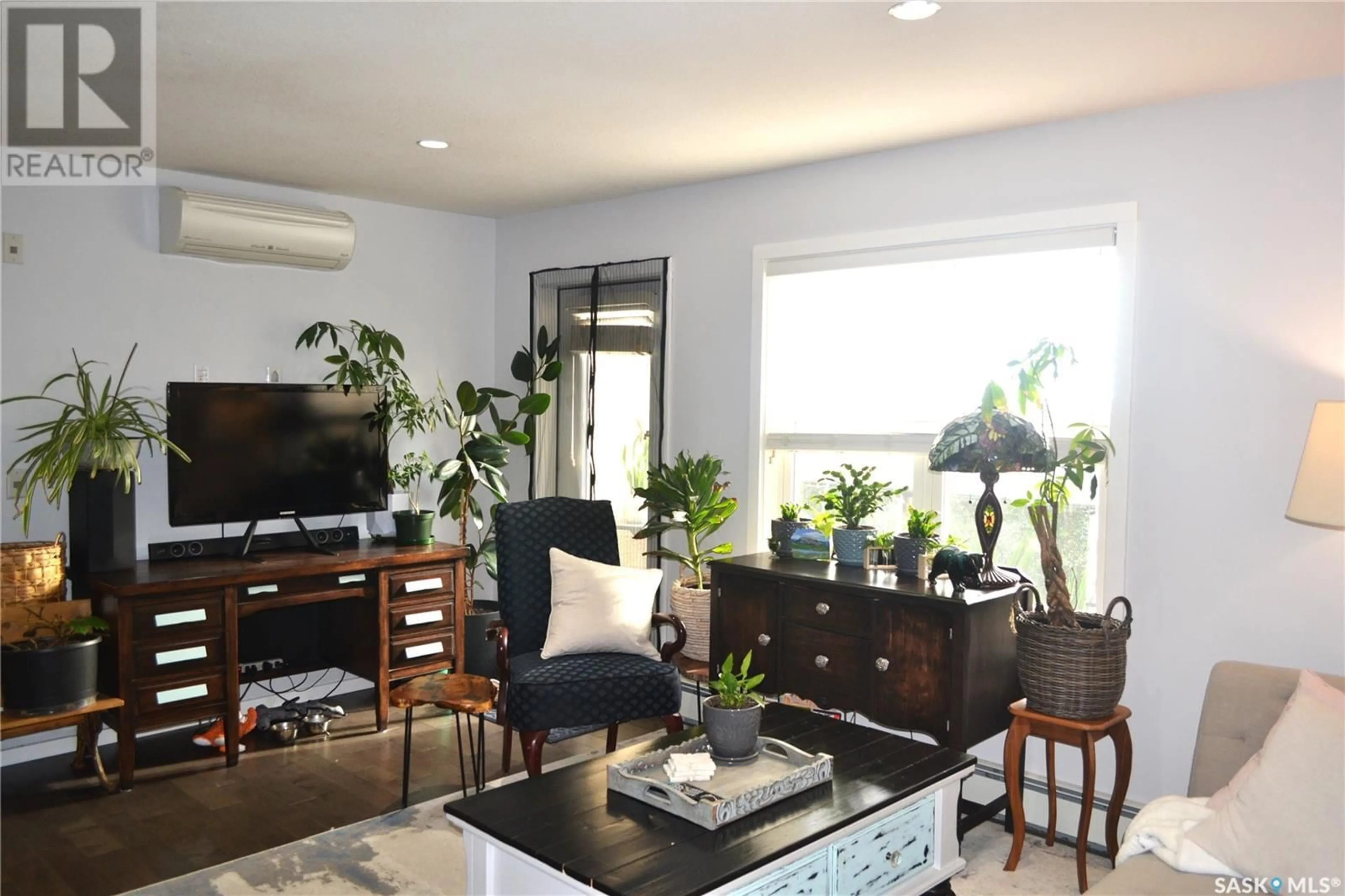 Living room with furniture, wood/laminate floor for 230 - 406 SLIMMON ROAD, Saskatoon Saskatchewan S7V0B3