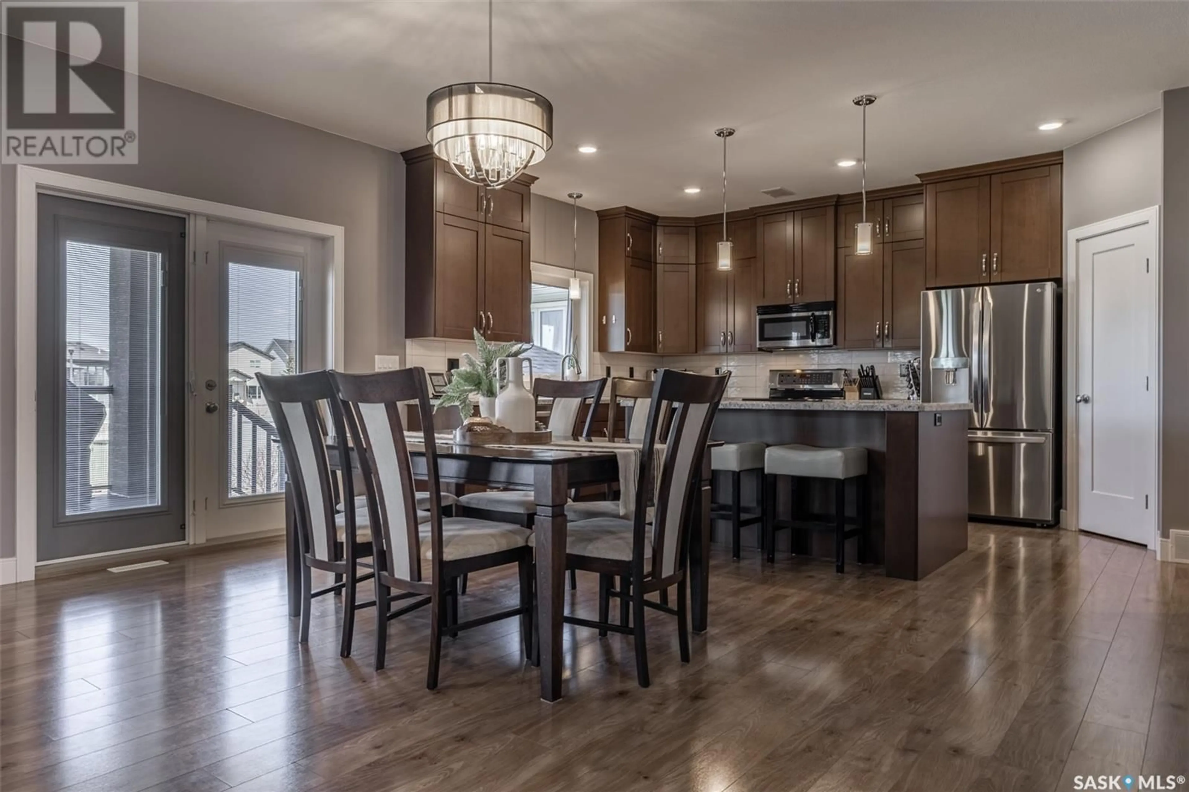 Open concept kitchen, wood/laminate floor for 610 CASPER COVE, Warman Saskatchewan S0K4S4
