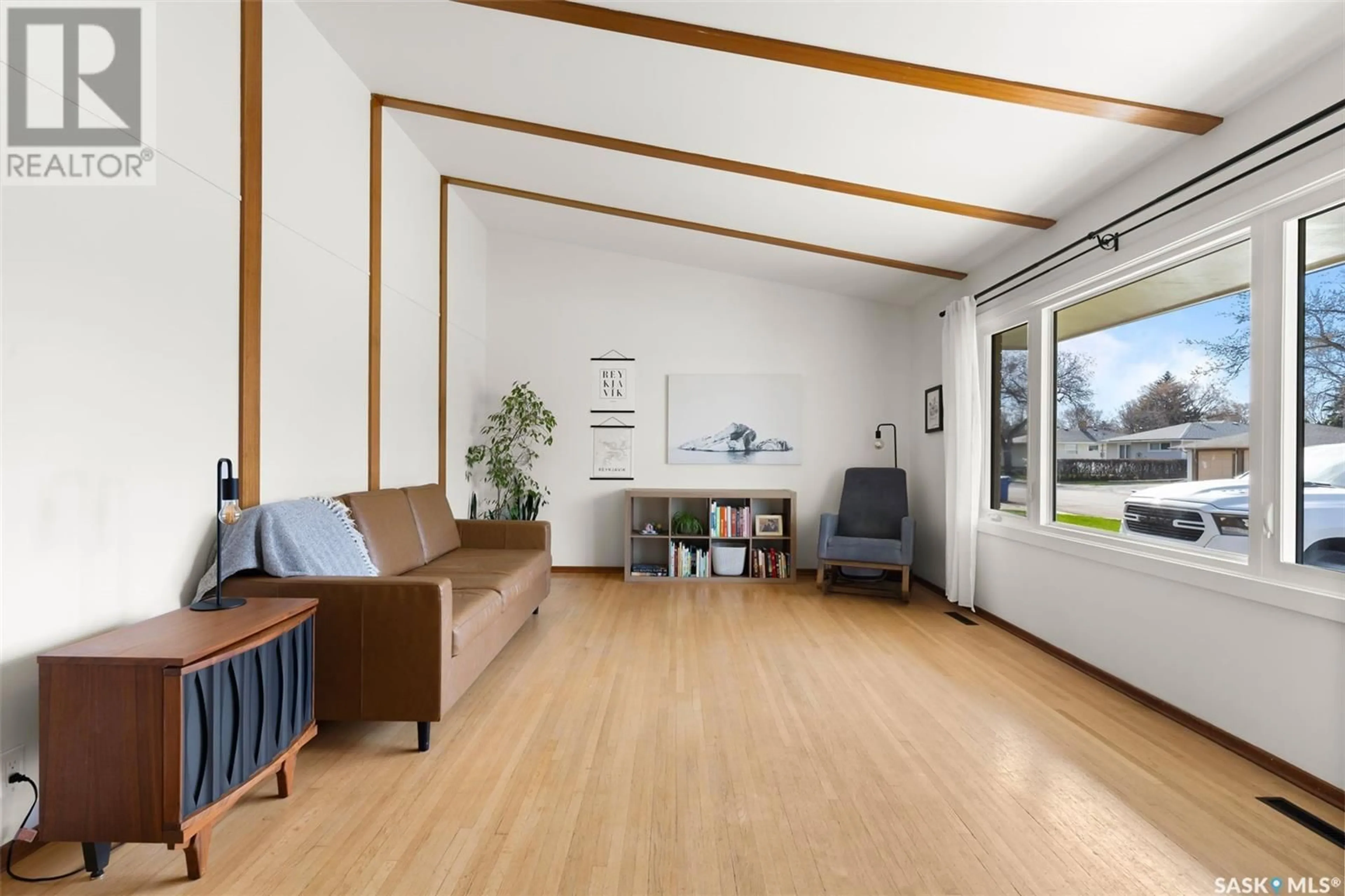 Living room with furniture, wood/laminate floor for 18 MILLAR CRESCENT, Regina Saskatchewan S4S1N2
