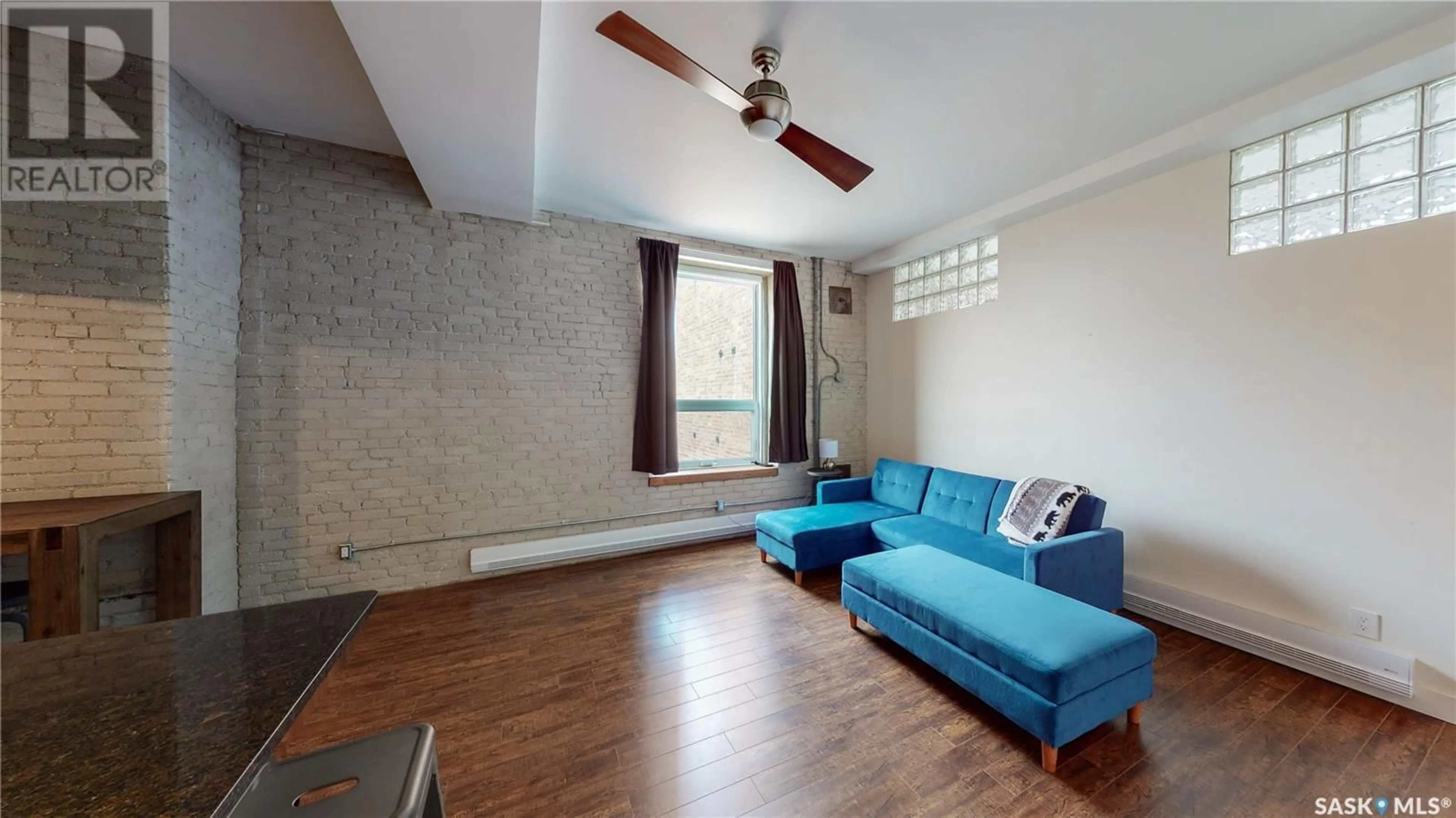 Living room with furniture, wood/laminate floor for 302 - 2128 DEWDNEY AVENUE, Regina Saskatchewan S4R1H2