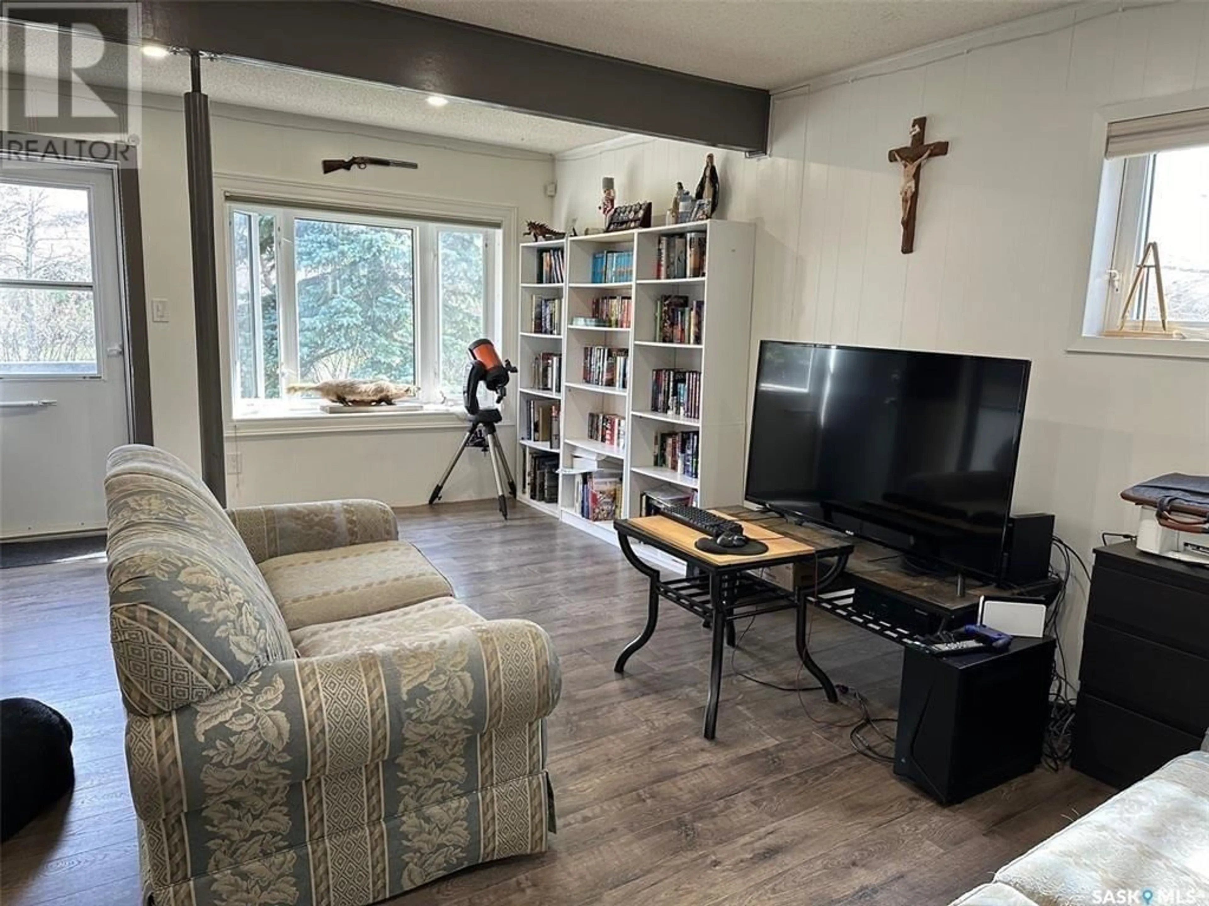Living room with furniture, wood/laminate floor for 301 BELFAST STREET, North Portal Saskatchewan S0C1N0